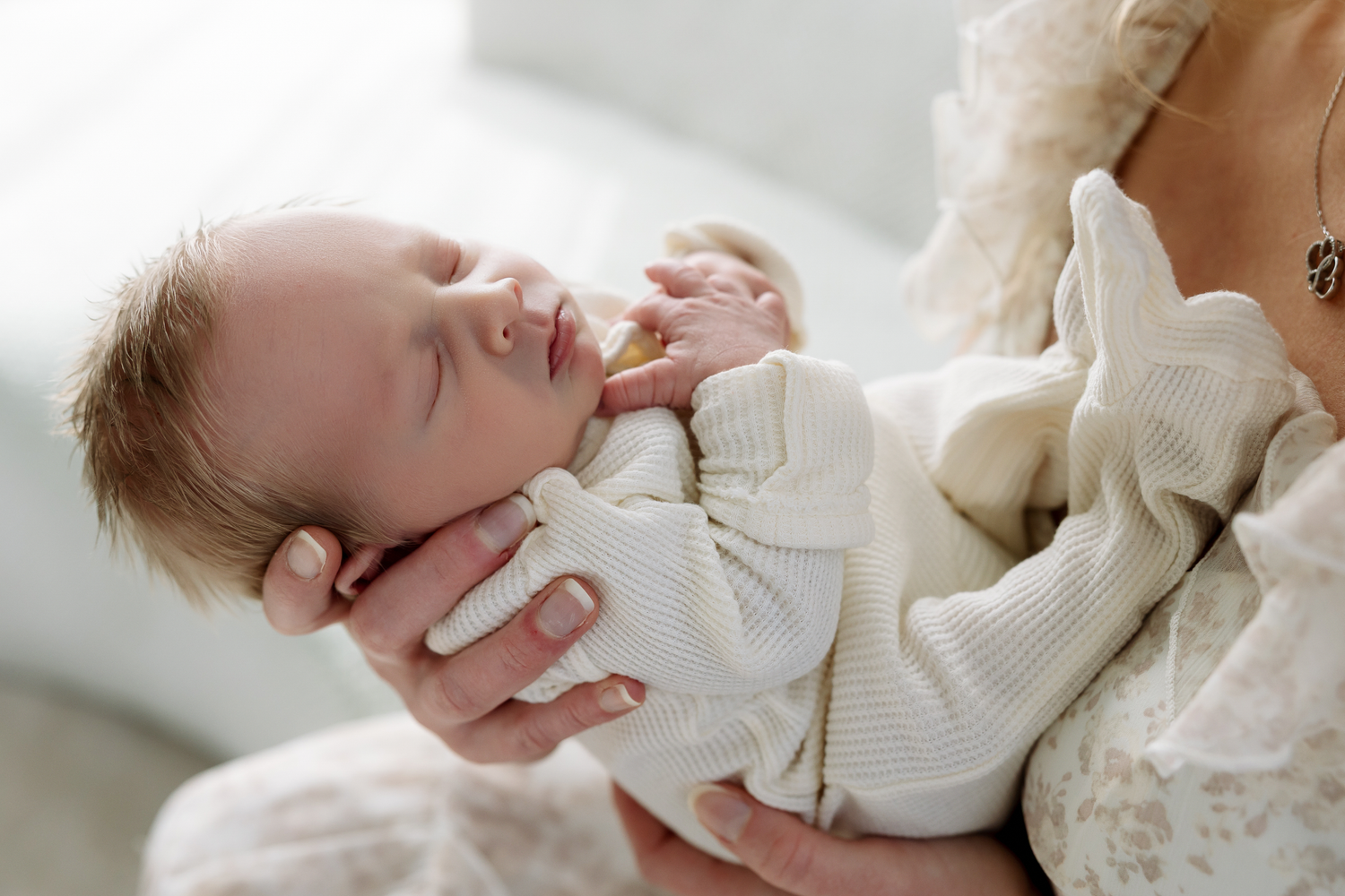 A series of peaceful images showing a sleeping baby in white clothing resting on soft bedding.