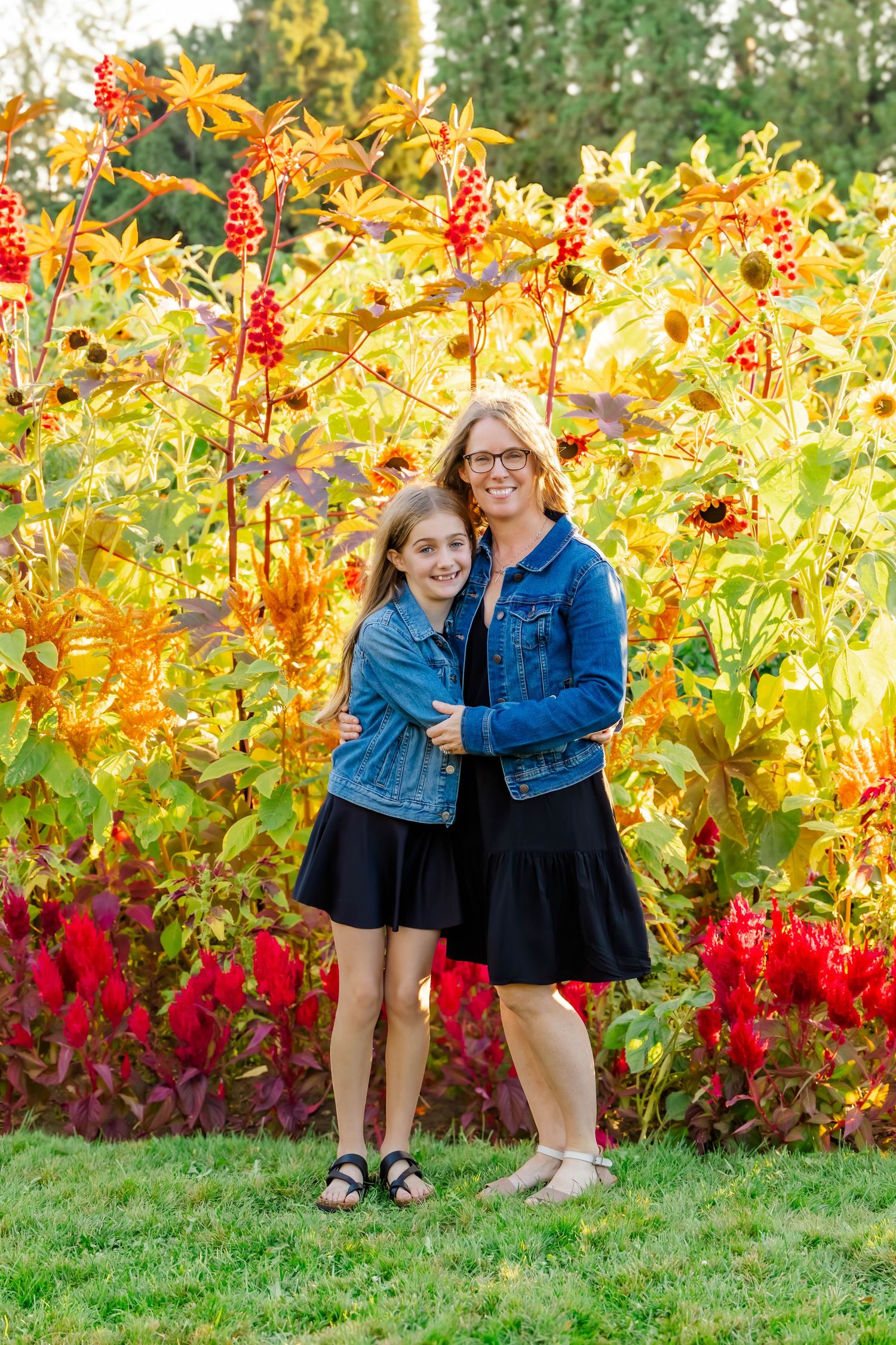 A series of casual outdoor portraits taken in front of a garden with bright yellow flowers and red foliage.