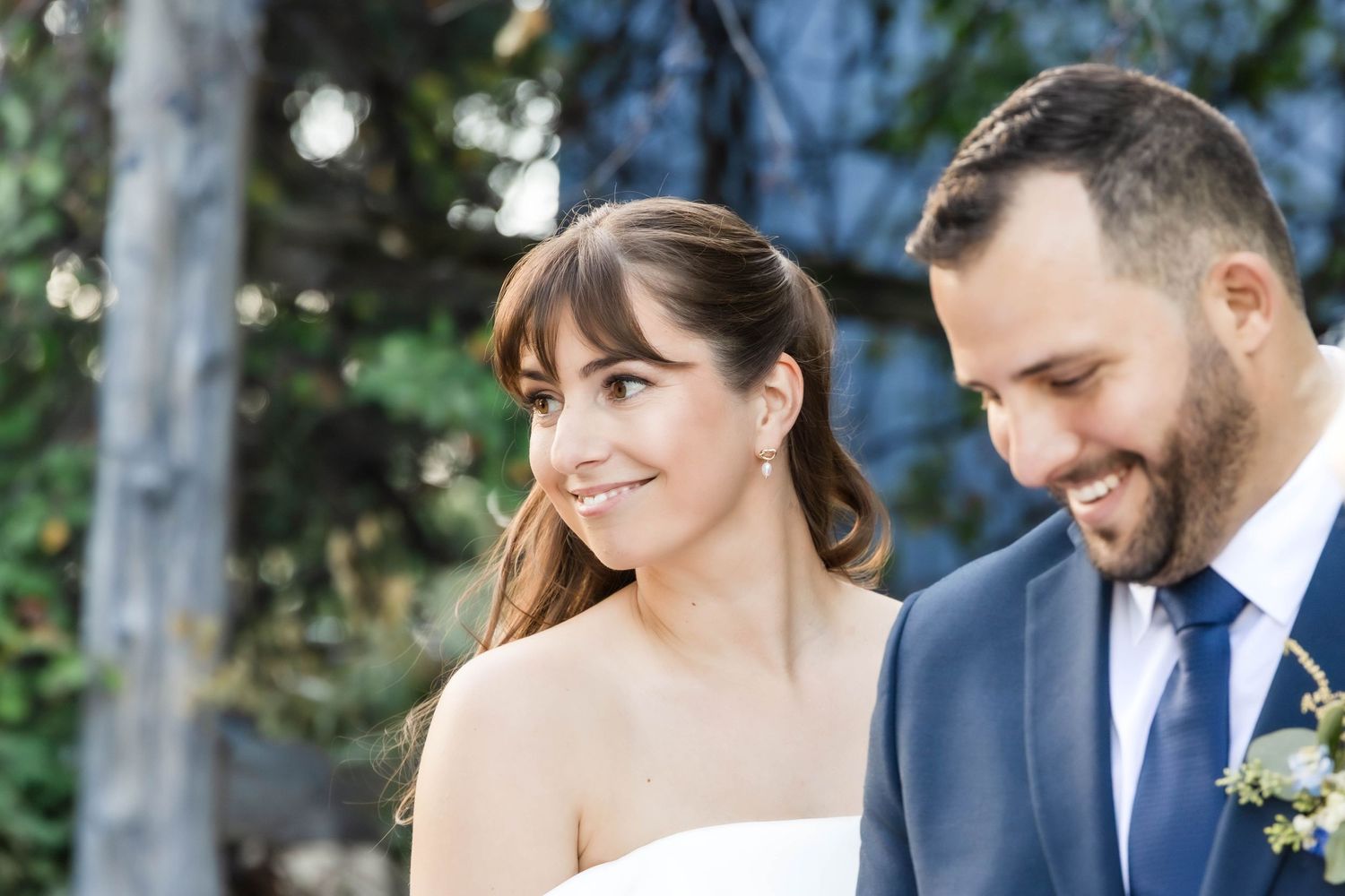 Wedding couple sharing an intimate moment during document signing at their outdoor ceremony.