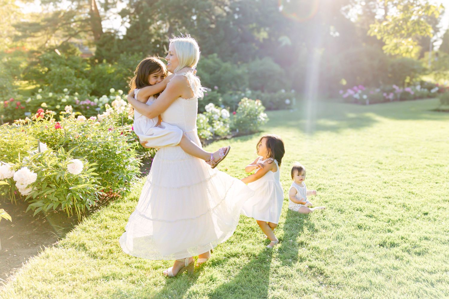 Summer garden photoshoot with natural lighting and white clothing.