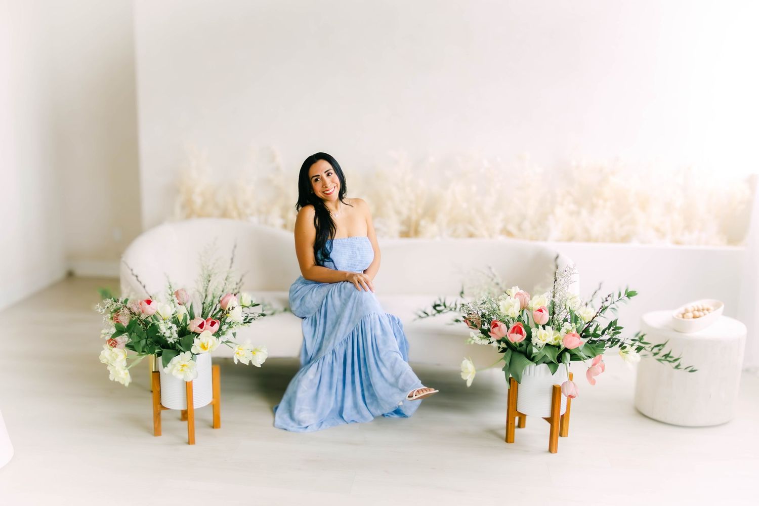 Studio session featuring light blue dress against white backdrop with floral elements.