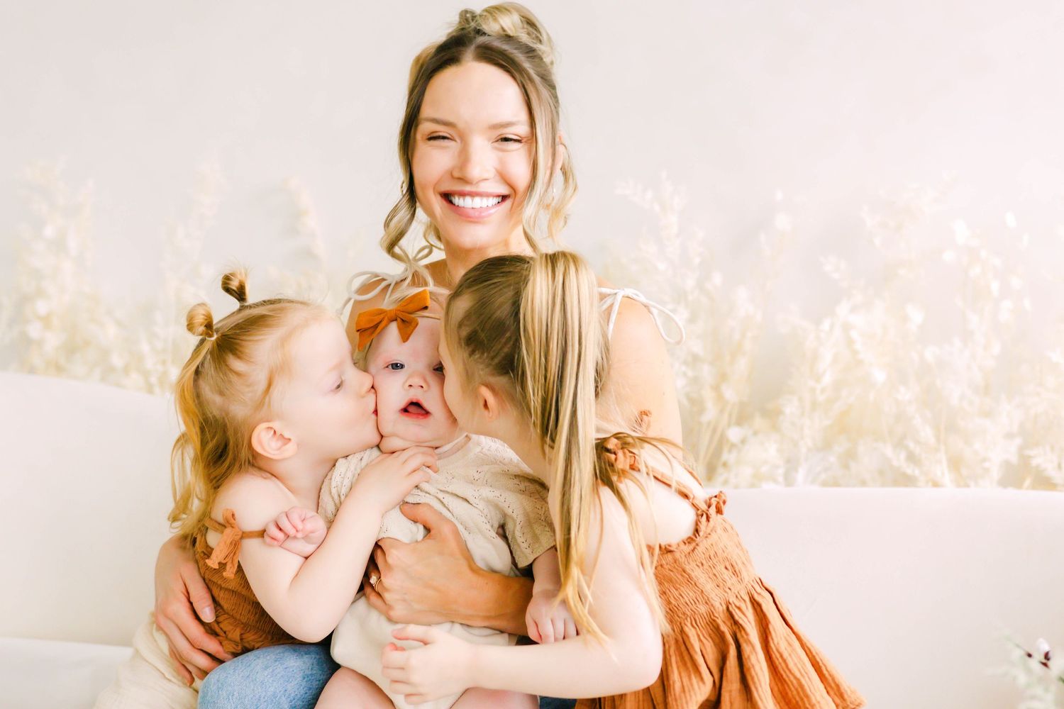 A series of bright, airy photographs showing tender family moments in a light-filled room with soft neutral tones.