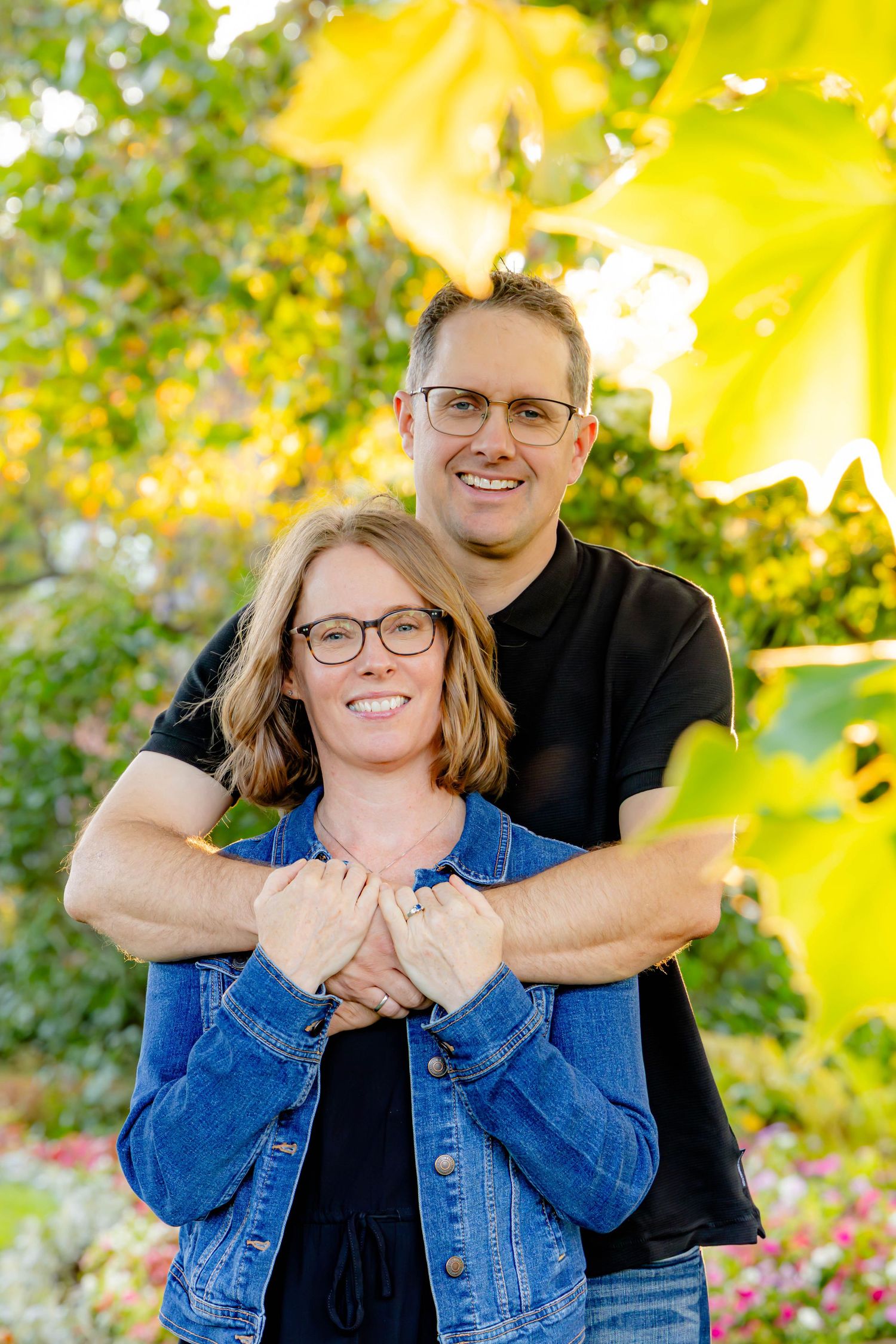 Outdoor portrait series with sunlit yellow flowers creating a warm natural backdrop.