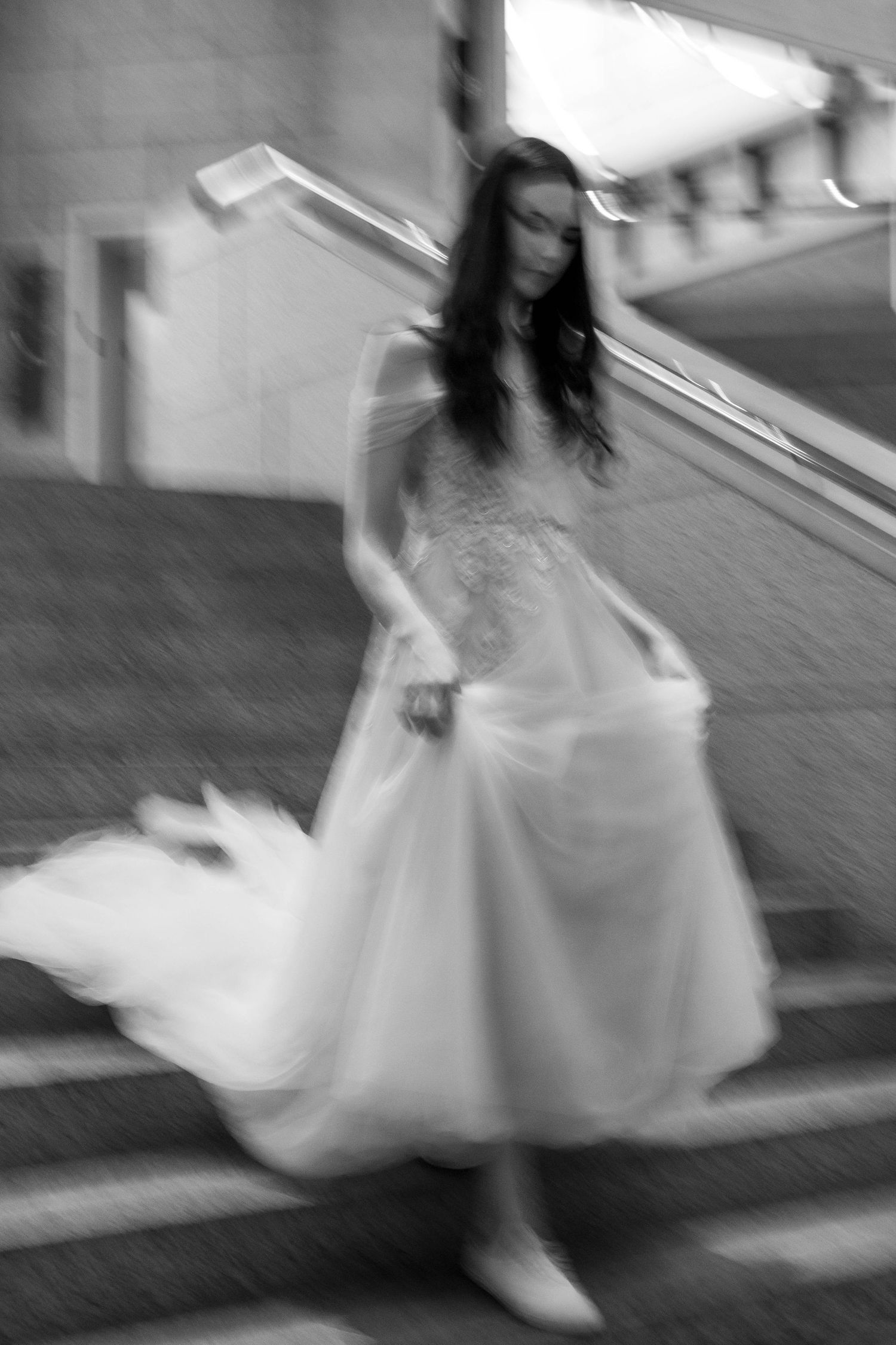 A series of motion-blurred images showing the flowing movement of a white wedding dress as someone walks.