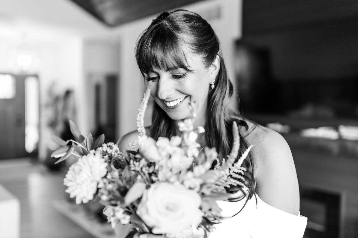 Black and white wedding photos showing intimate moments between newlyweds with elegant floral bouquet details.