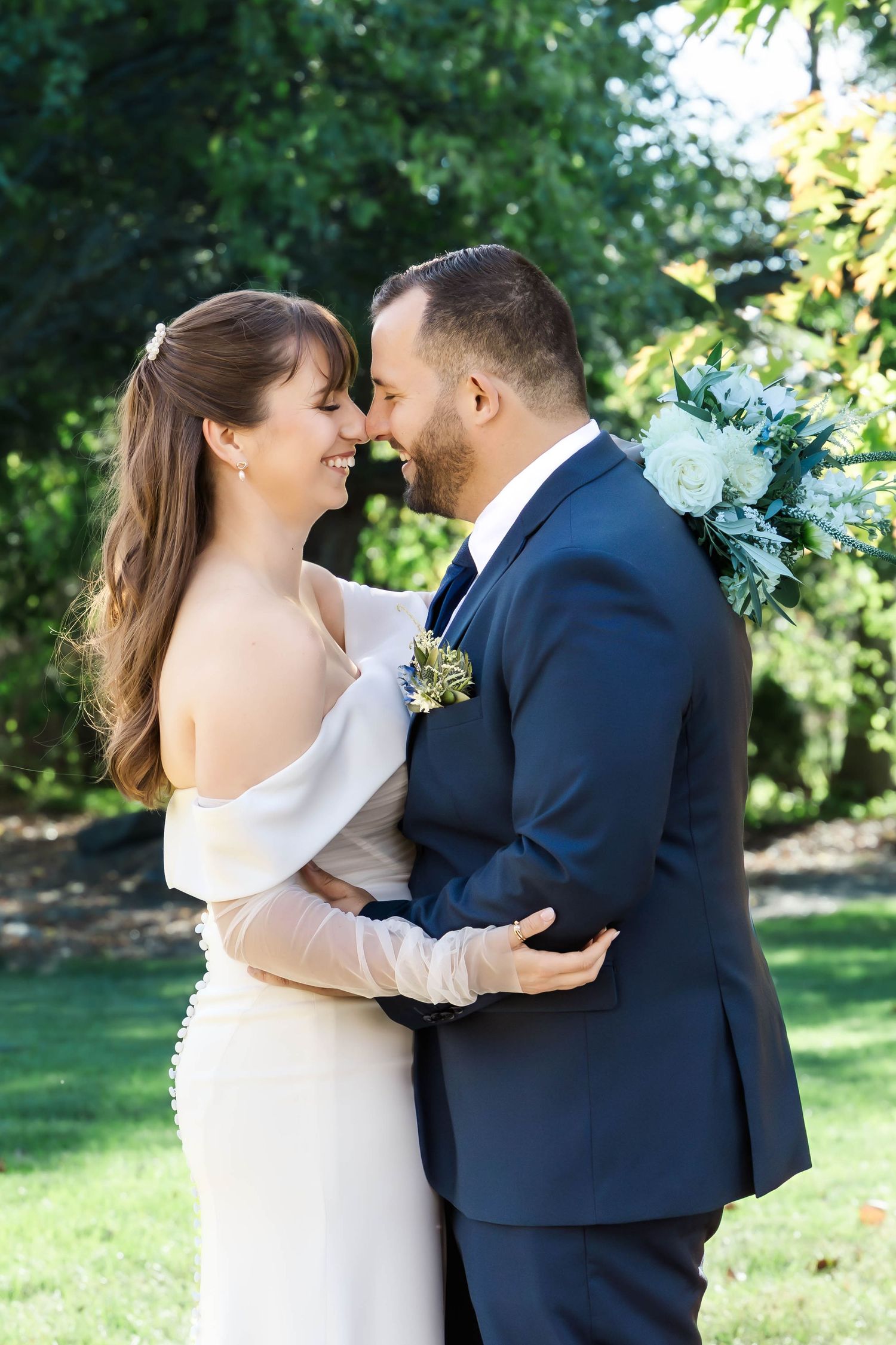 Candid moments between newlyweds sharing laughter and embraces in a sunlit garden setting.