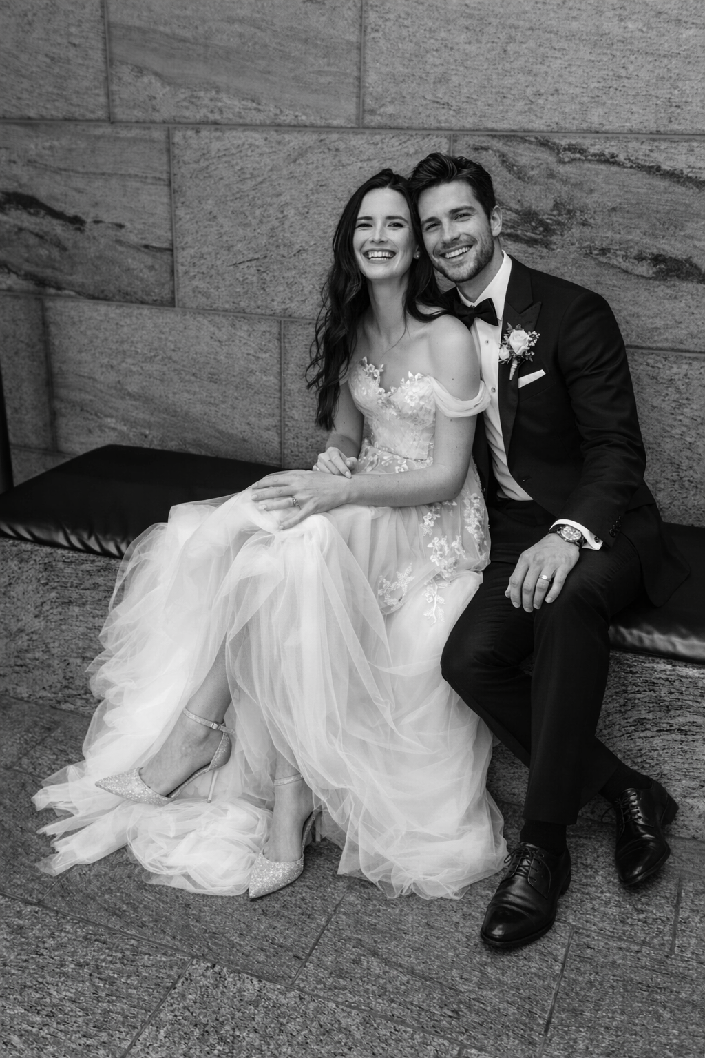 A series of romantic wedding photos showing a couple sitting together on stone steps in black and white.