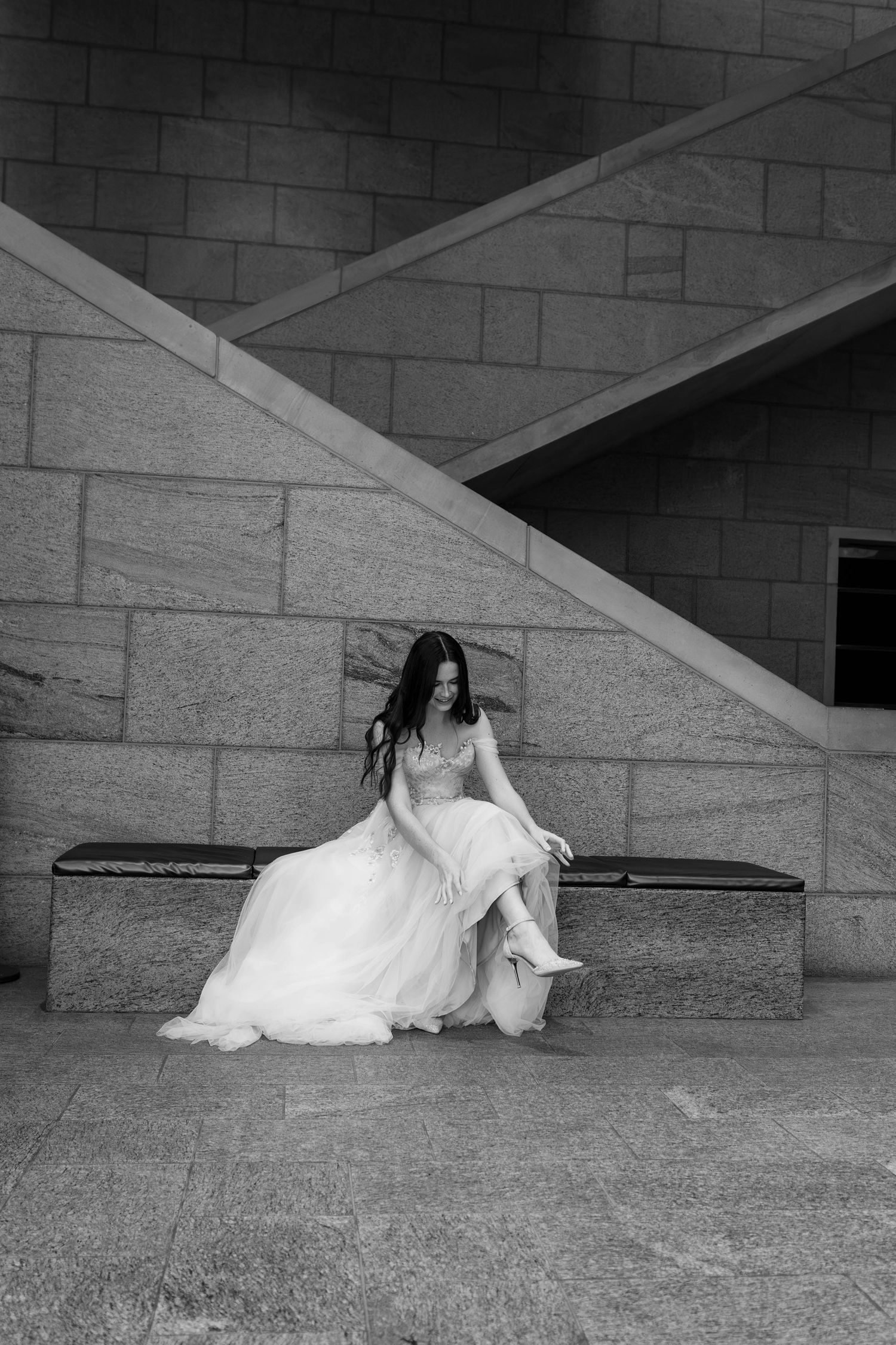 A sequence of artistic black and white bridal portraits showing a woman reclining against architectural steps.