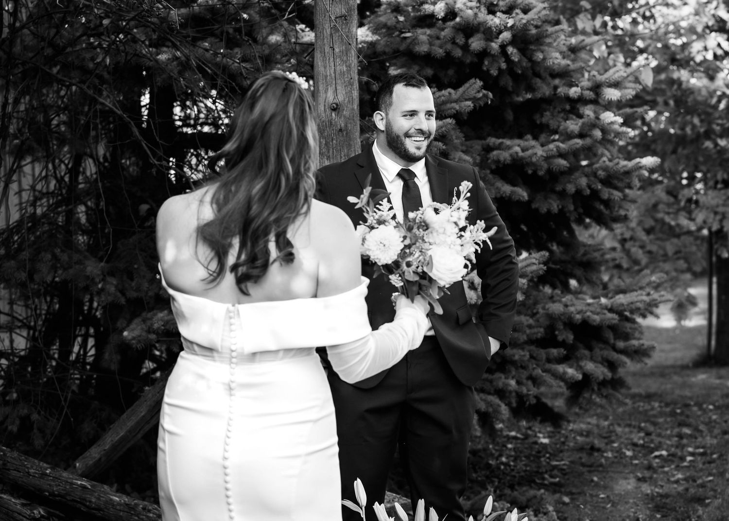 Black and white wedding photos capture intimate moments between a couple in formal attire.
