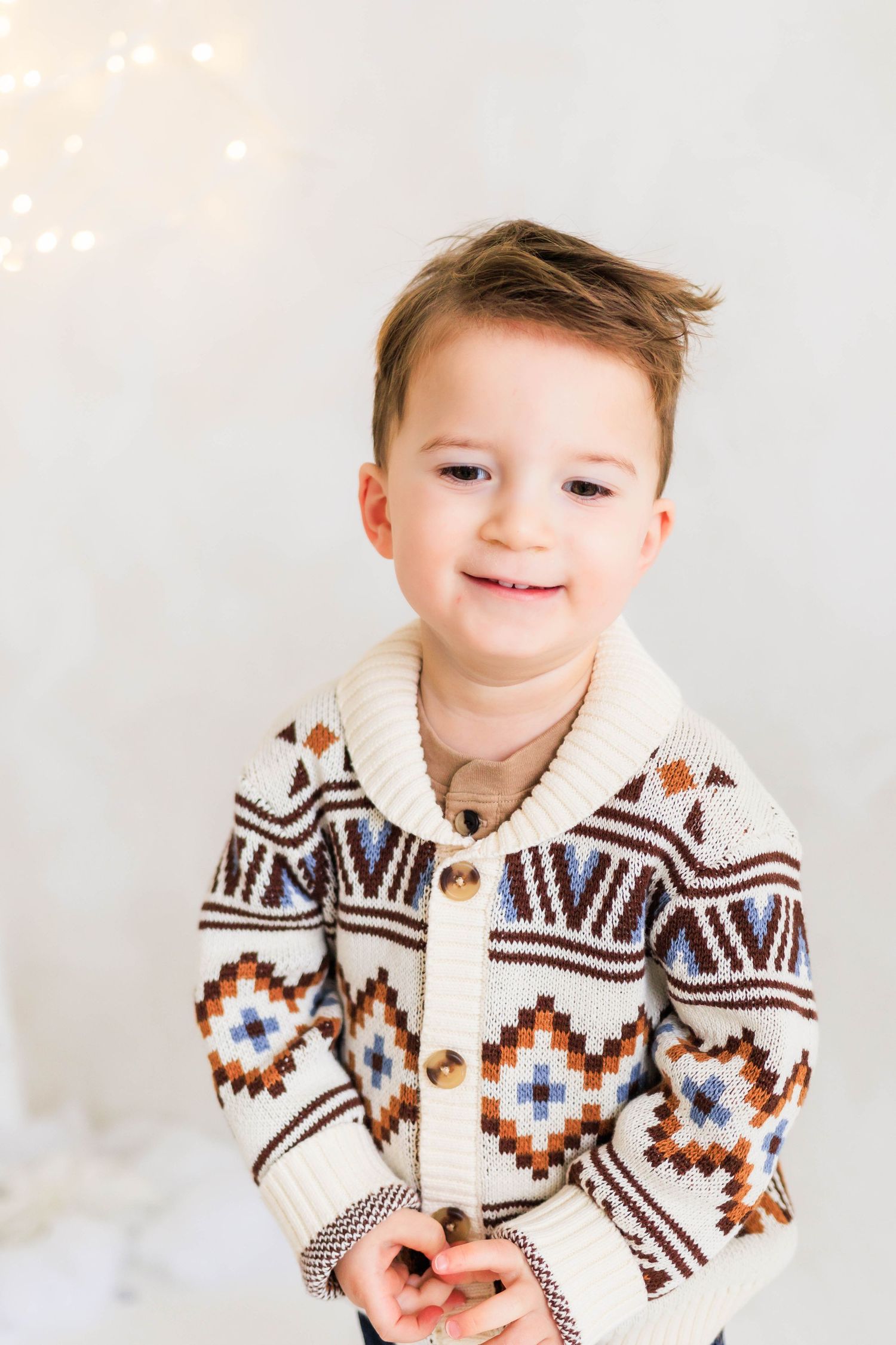 Close-up portrait wearing patterned winter sweater with geometric designs.