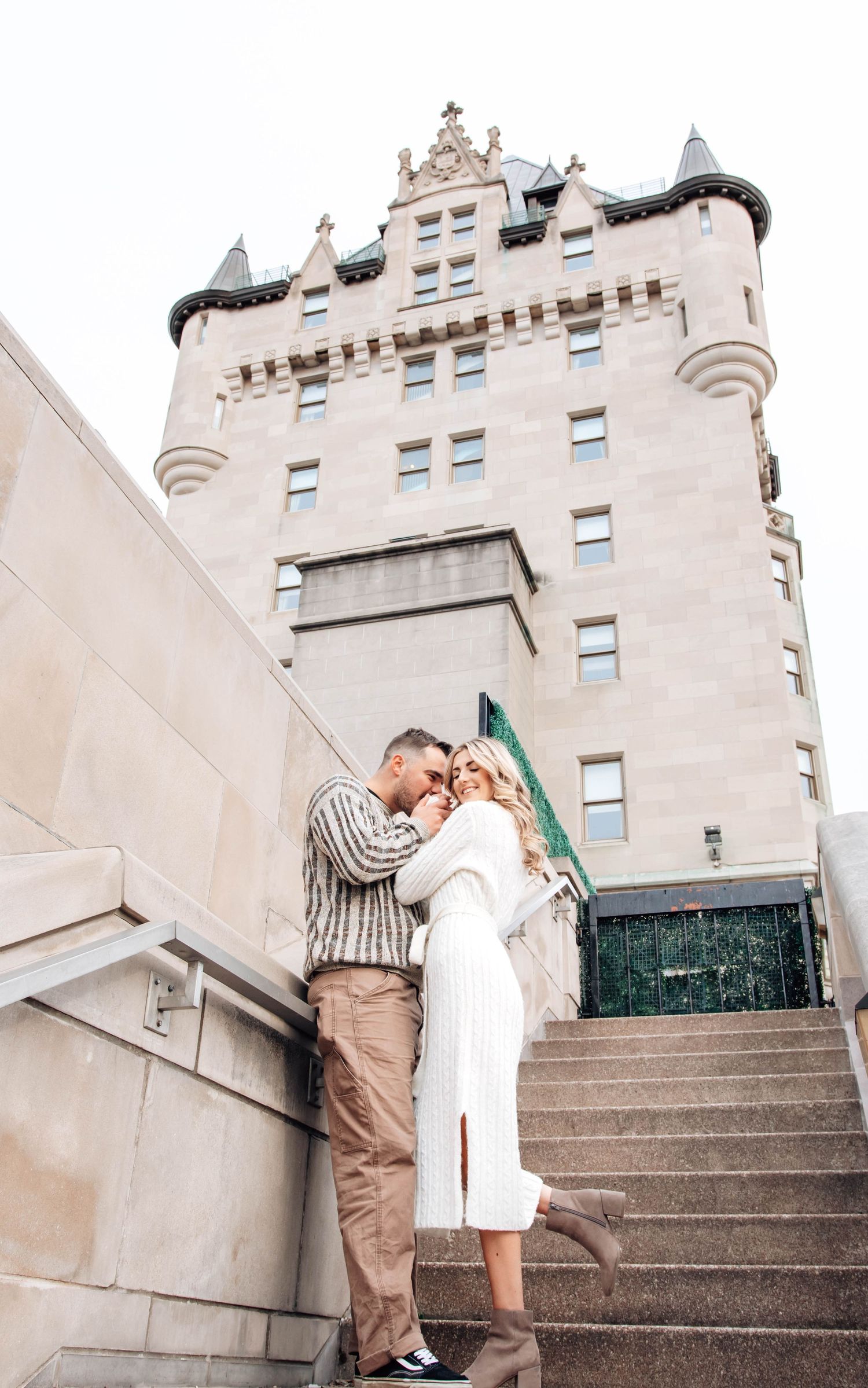 A couple shares romantic moments on stone steps in front of a historic building in a series of progressive photos.