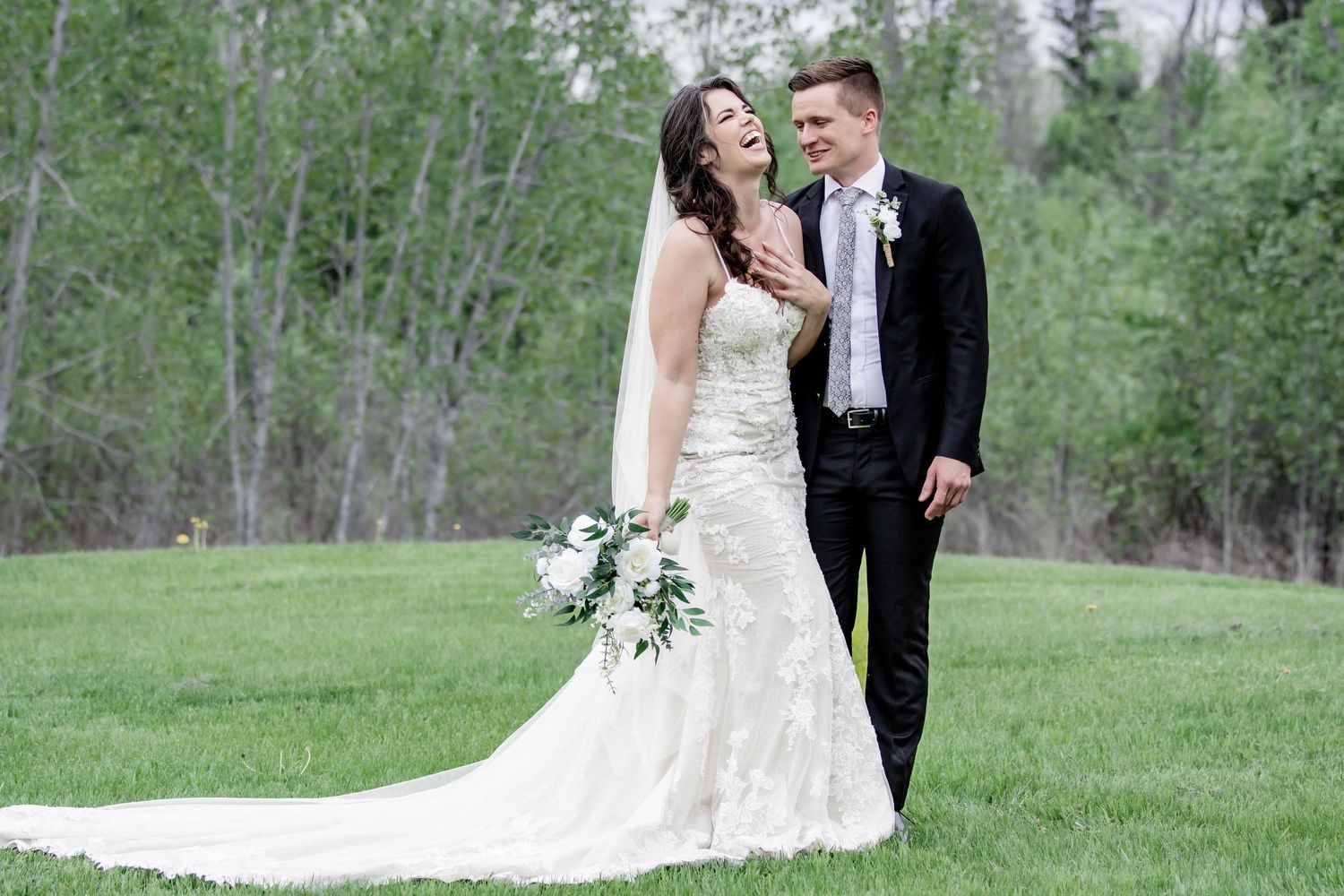 Romantic wedding portraits captured in a serene forest setting with natural lighting.