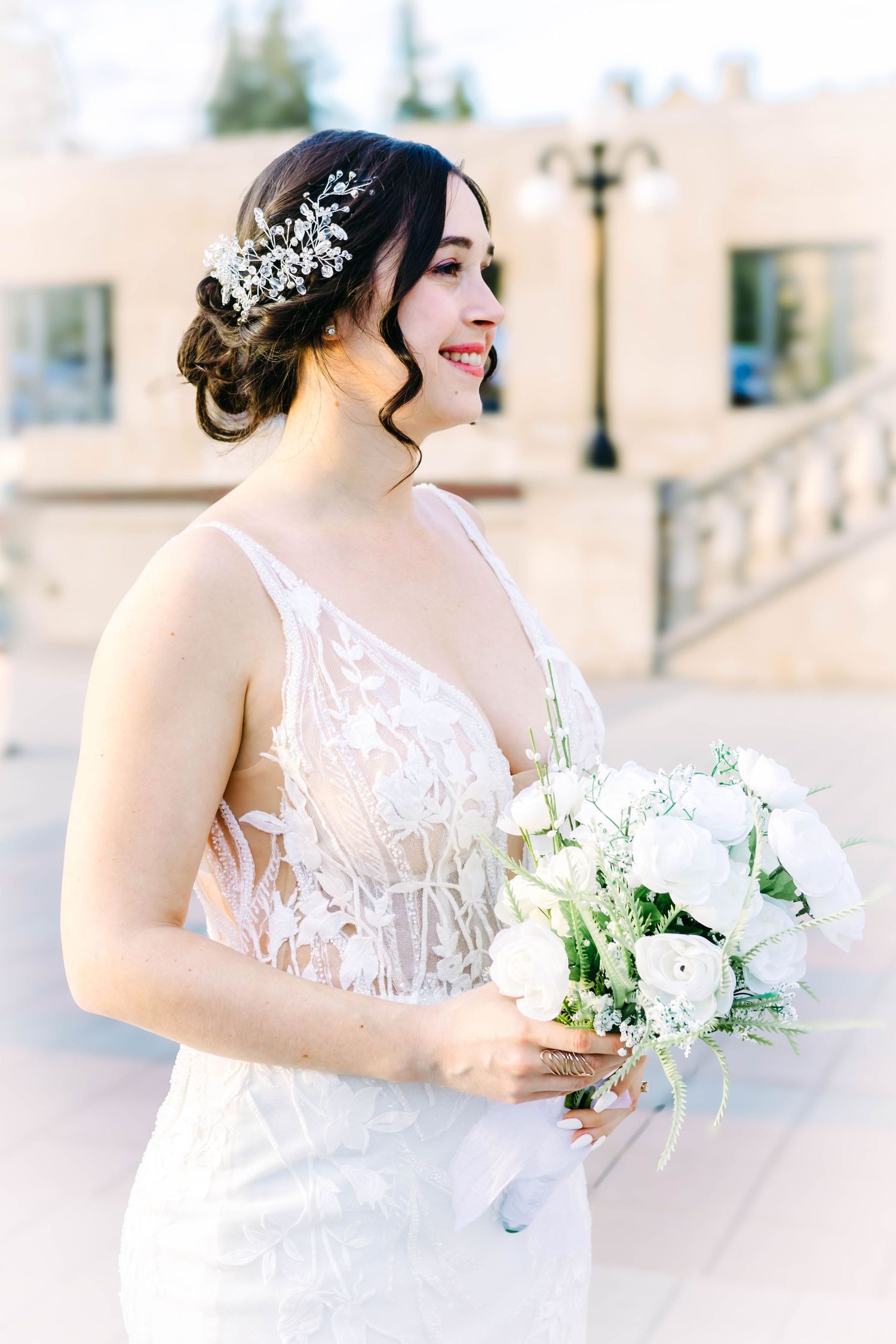 Sunlit bridal portraits featuring white bouquet and ornate hair accessories.
