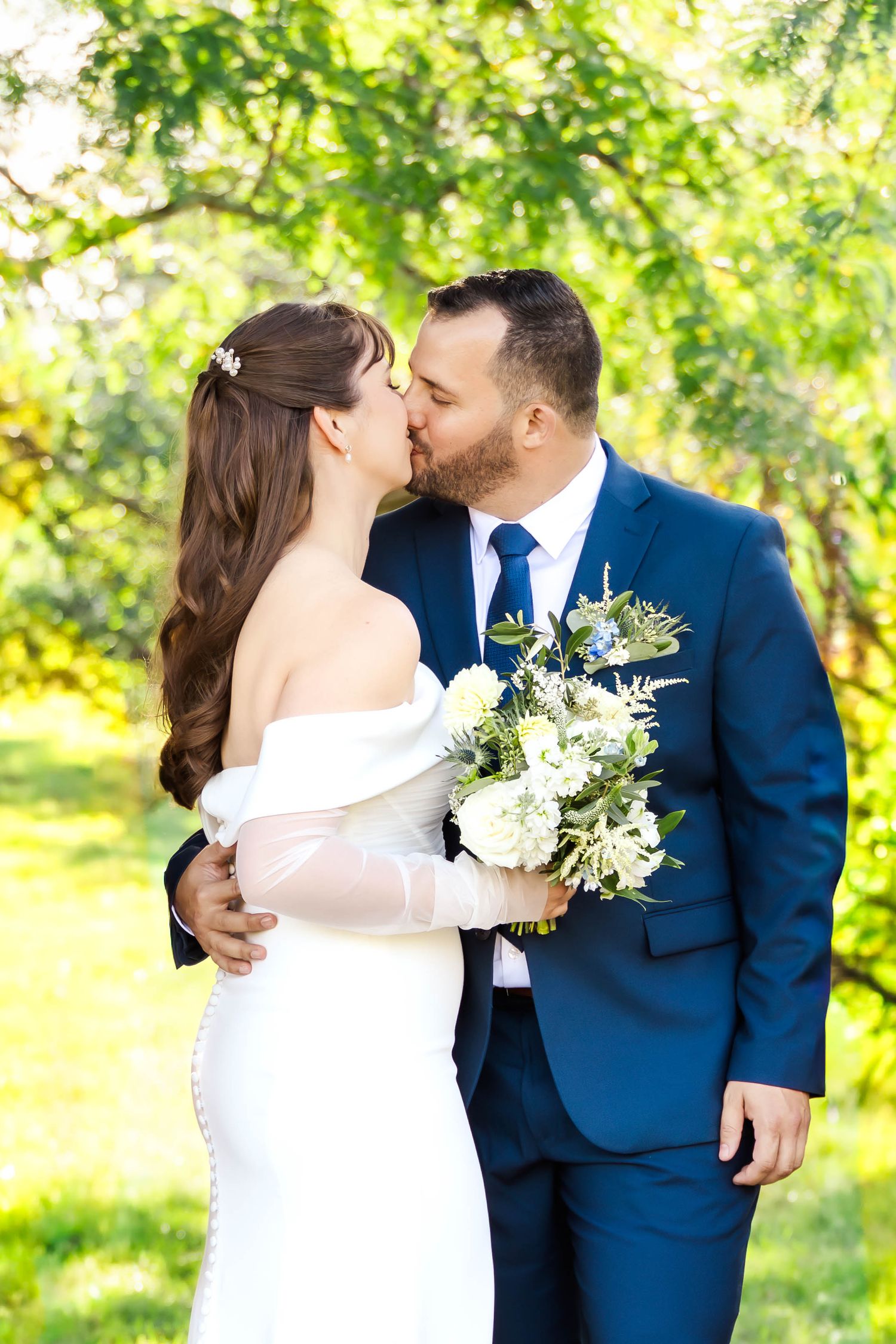 Romantic wedding kisses captured in sequence against leafy green background.