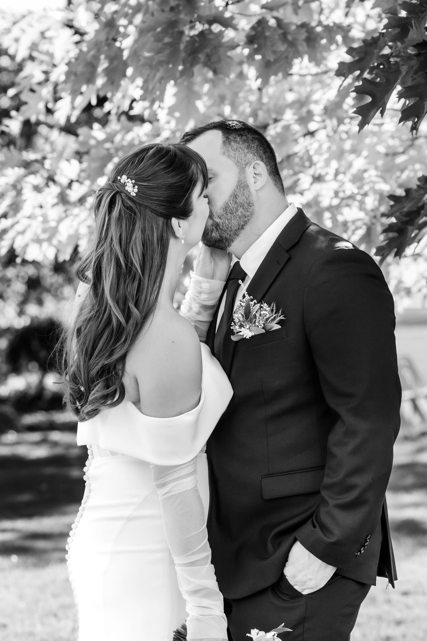 Intimate black and white wedding photos showing tender moments between newlyweds.
