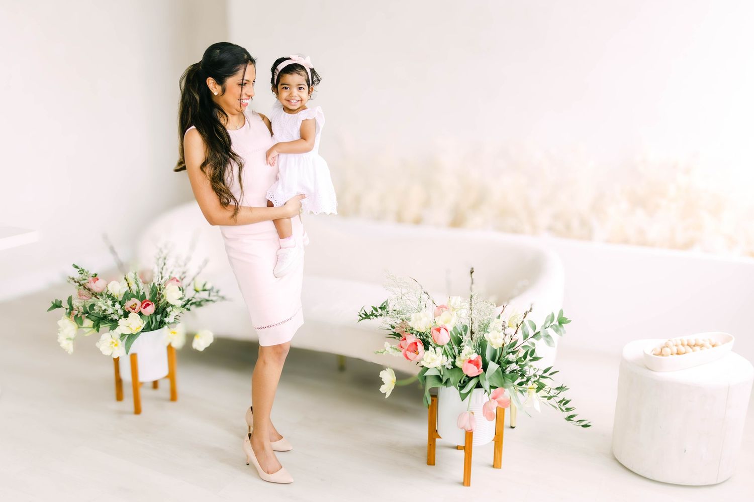 Intimate studio portraits with decorative floral elements and natural lighting.