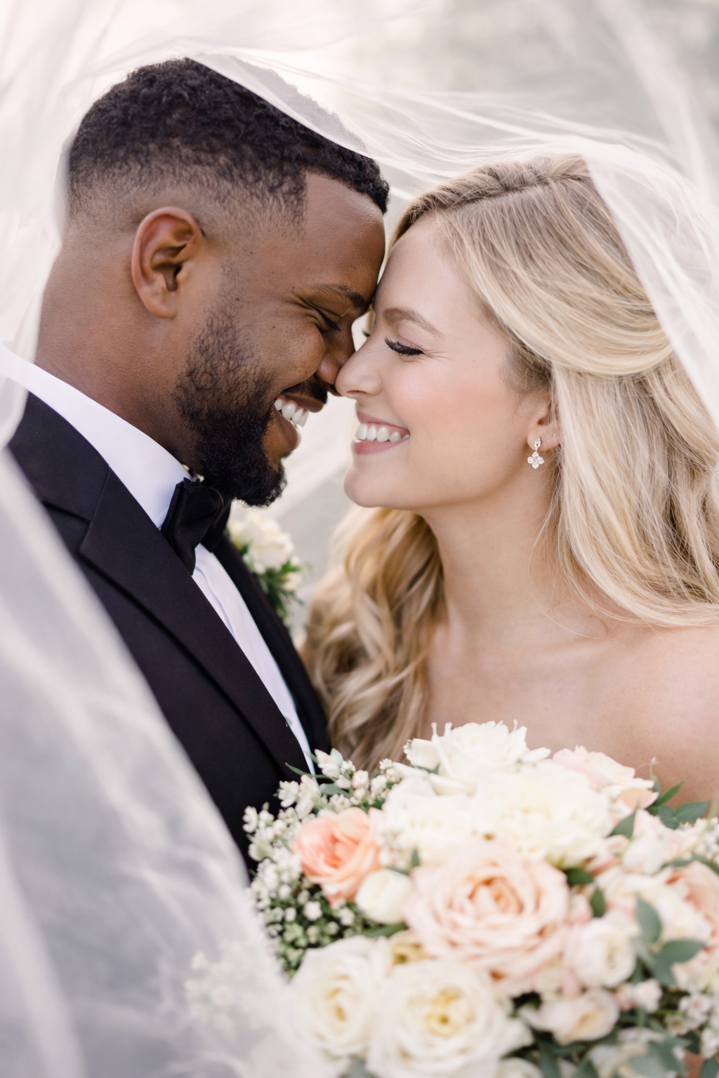 A romantic wedding photo series showing close-up moments between a bride and groom with peach-colored floral bouquet.