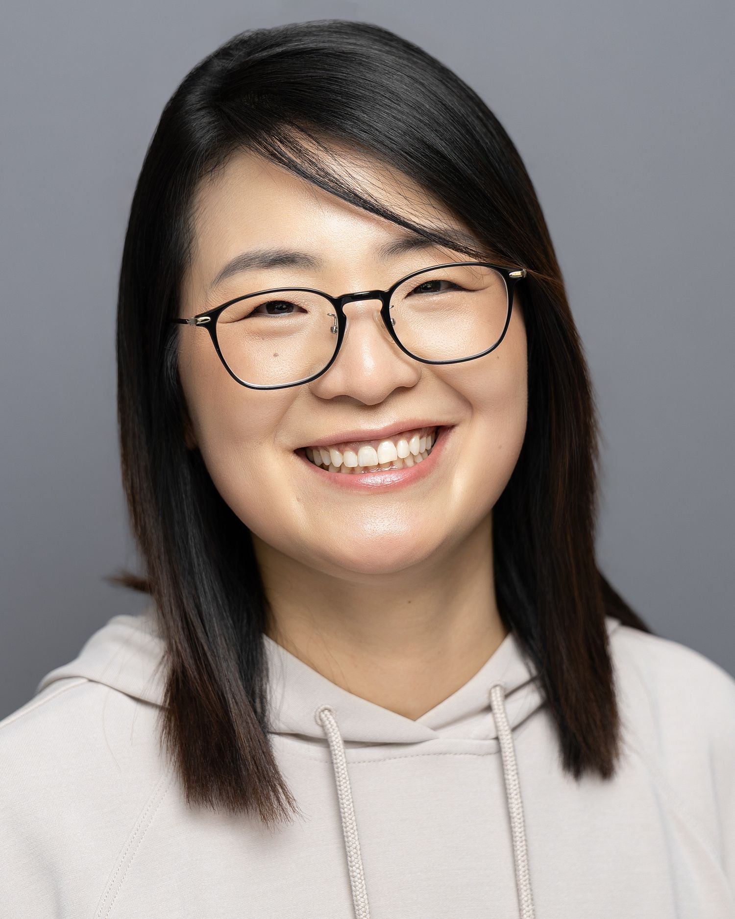 Confident business professional photographed against a neutral studio background
