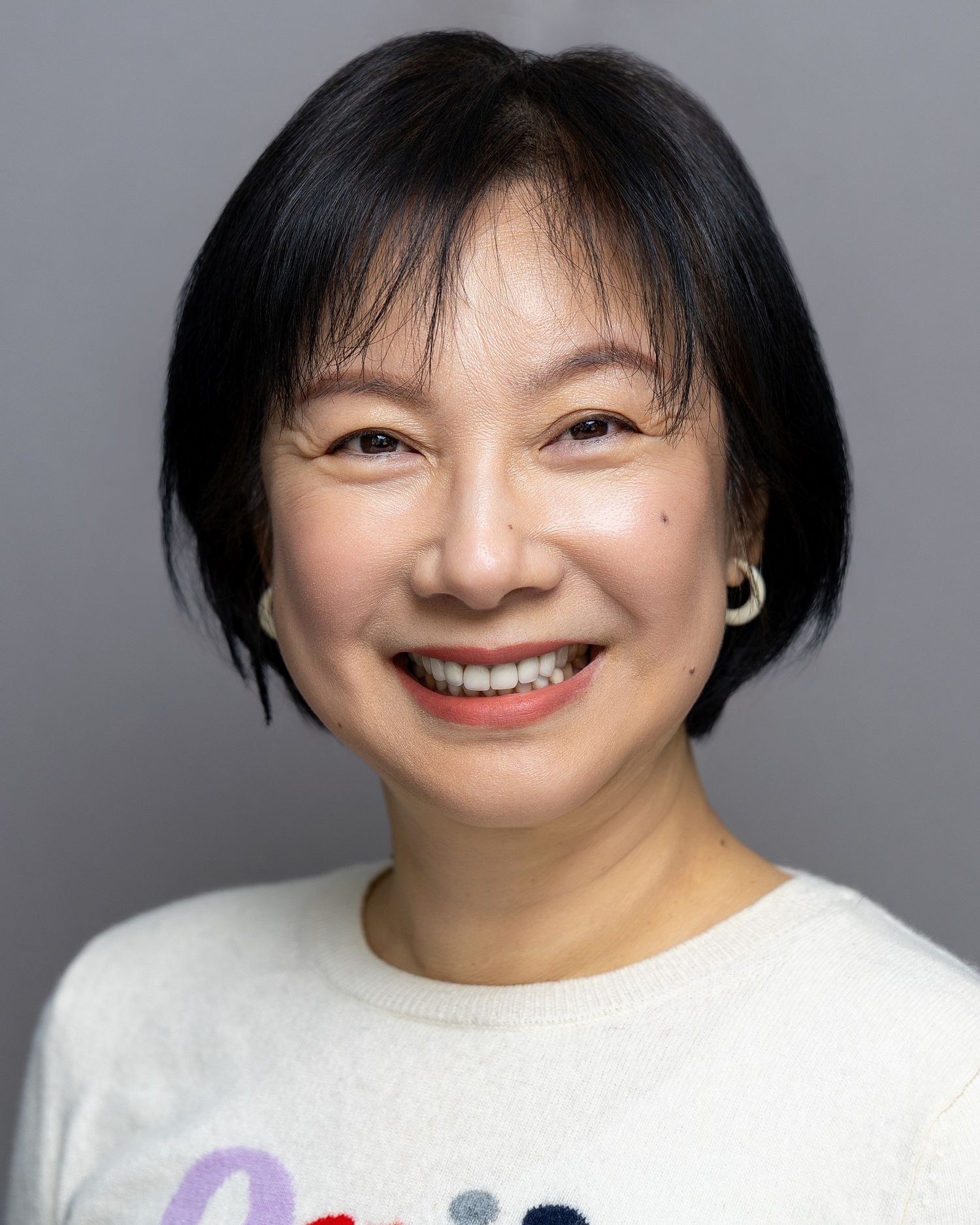 Professional LinkedIn headshot of a woman with a warm, confident expression