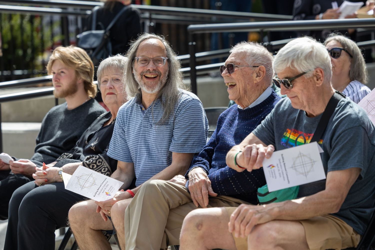 Community members chatting a building project celebration at a church in Seattle.