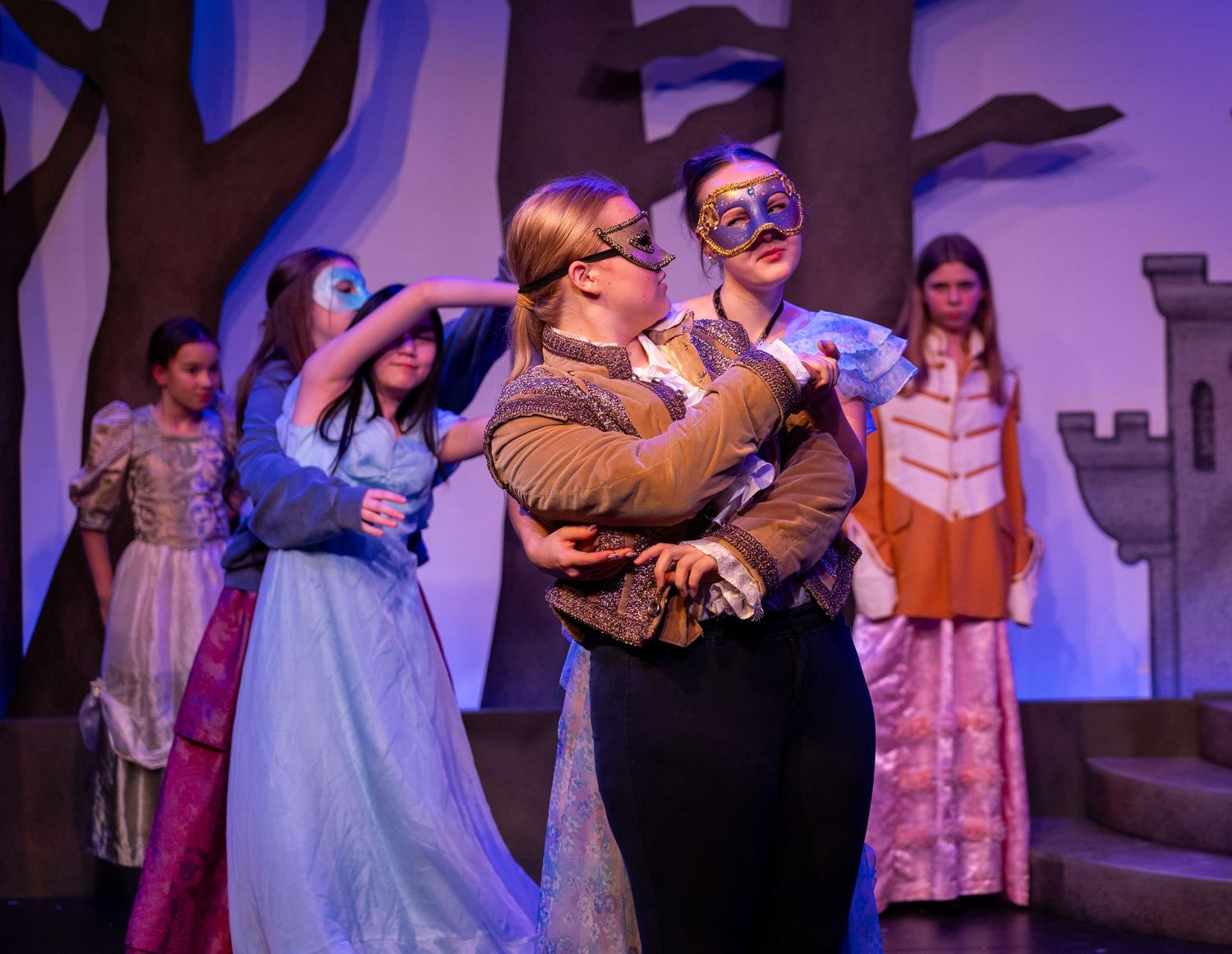 Actors mid-performance on stage in Kirkland