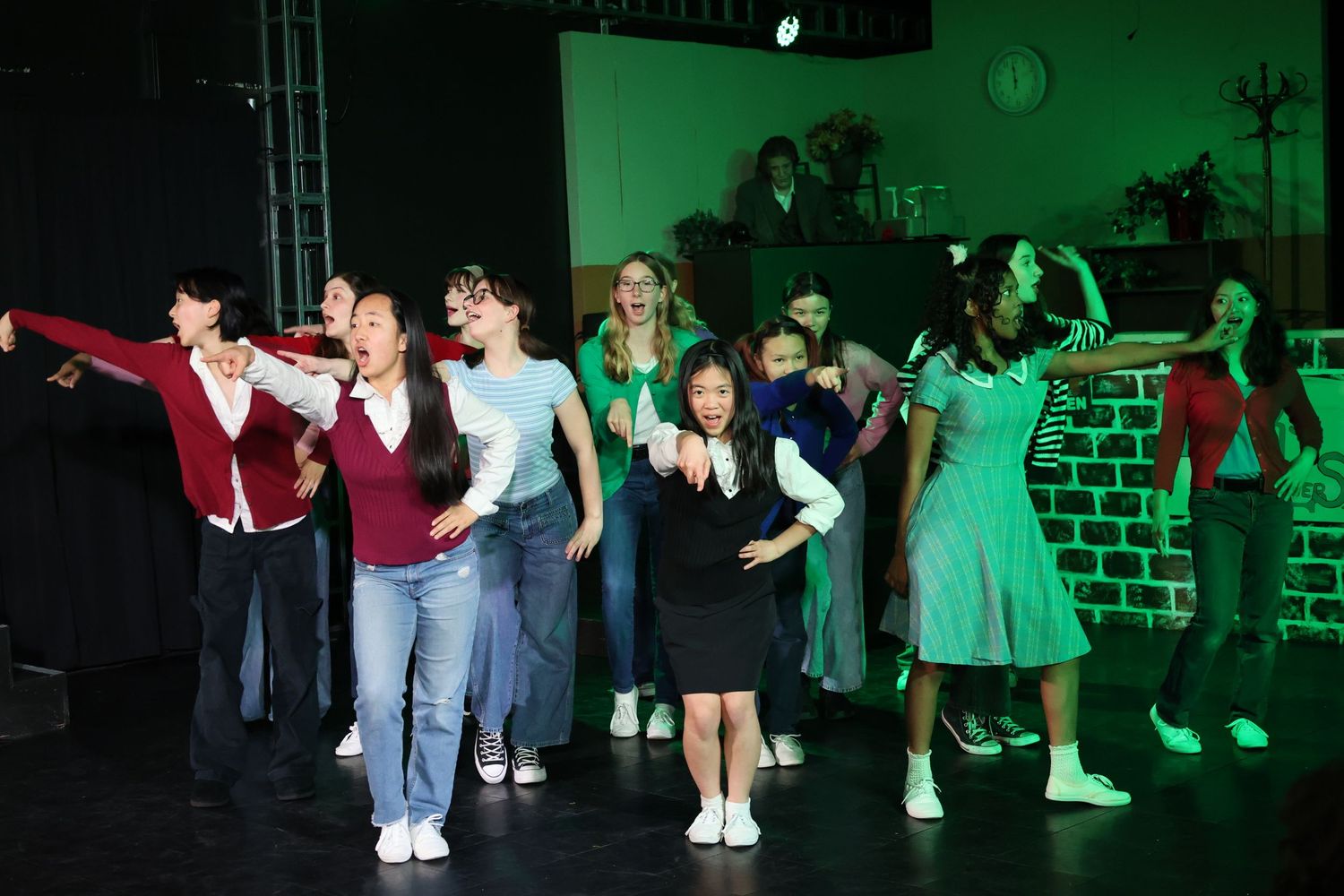 Ensemble cast singing and dancing on stage in Redmond