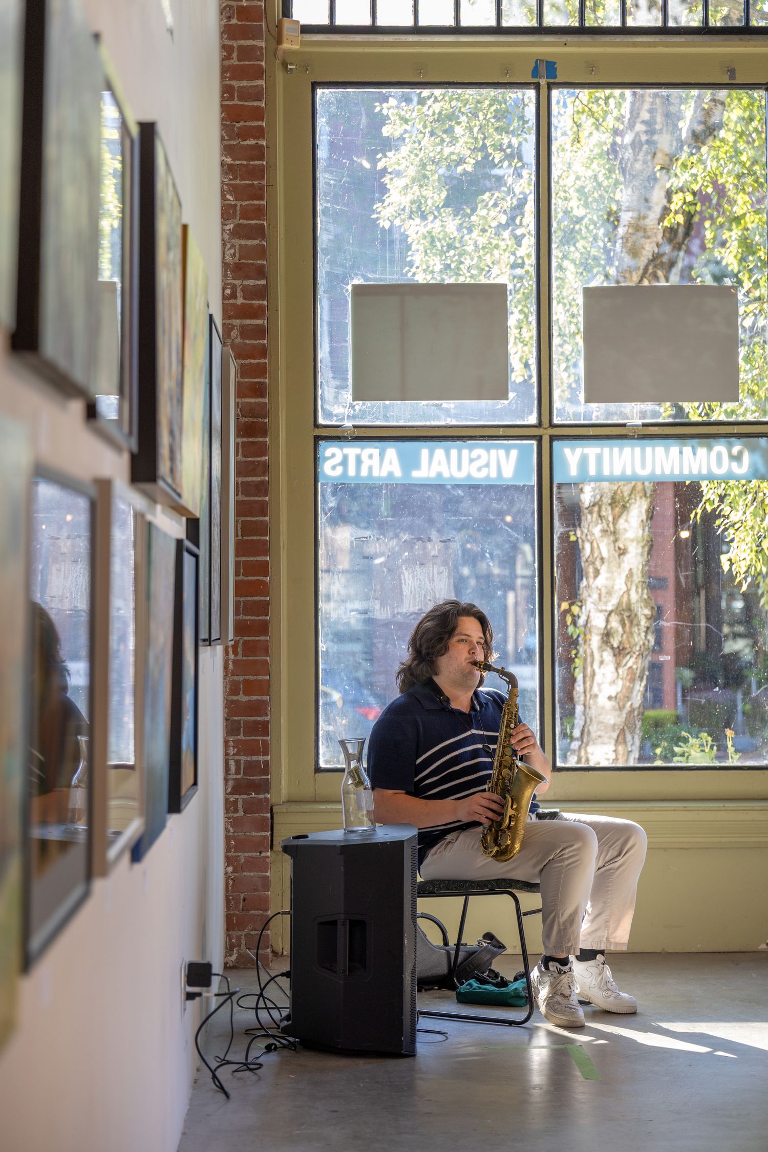 Saxophonist performing music at community event in Kirkland art gallery