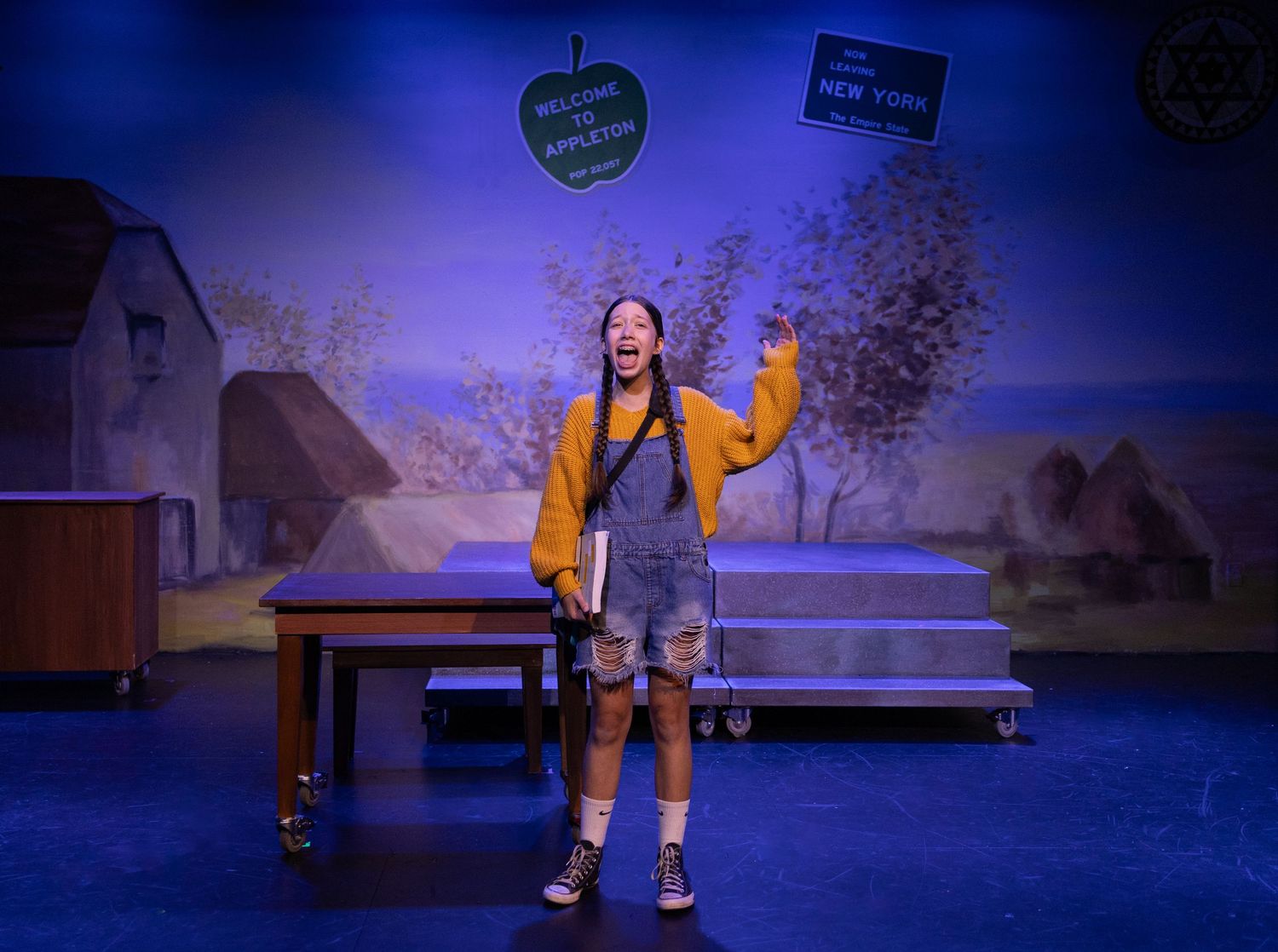 Stage scene with actor in character under lighting in Kirkland