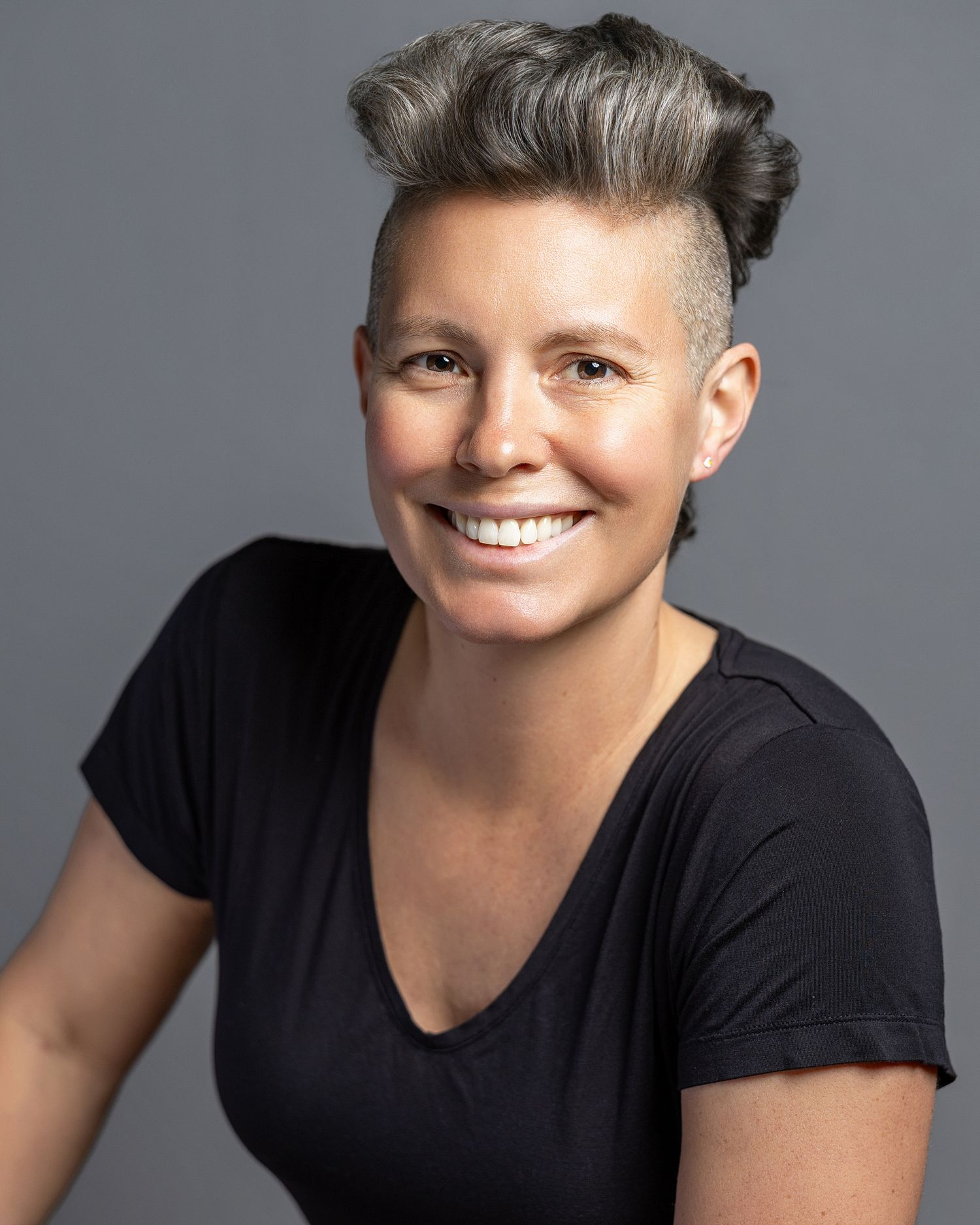 Corporate team member smiling for an on-site business headshot session