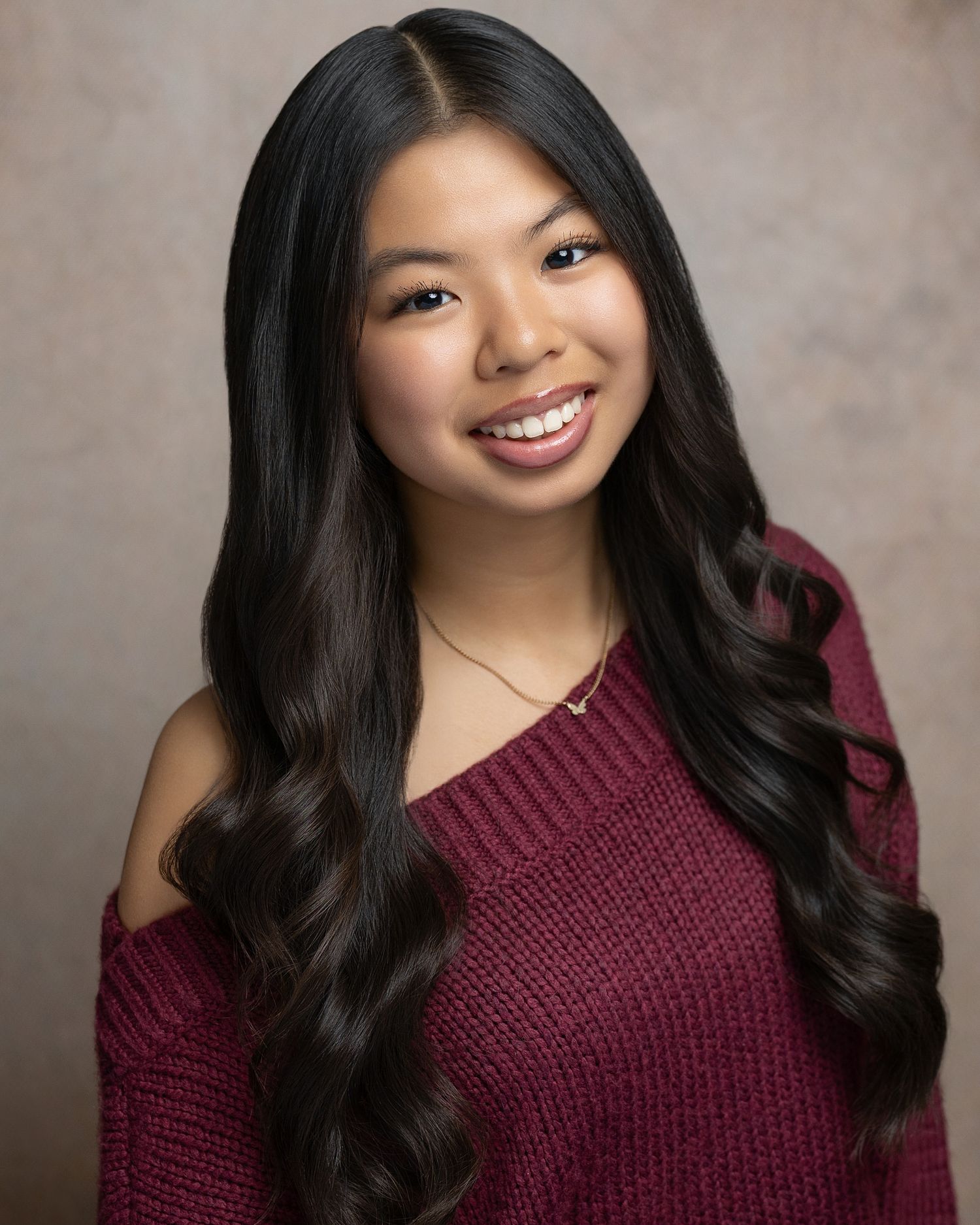Professional theatre actor headshot featuring a natural smile and bright expression