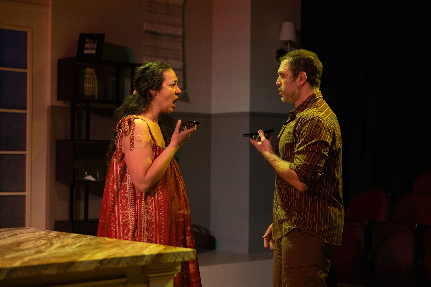 Actors performing on stage under theatrical lighting in Seattle