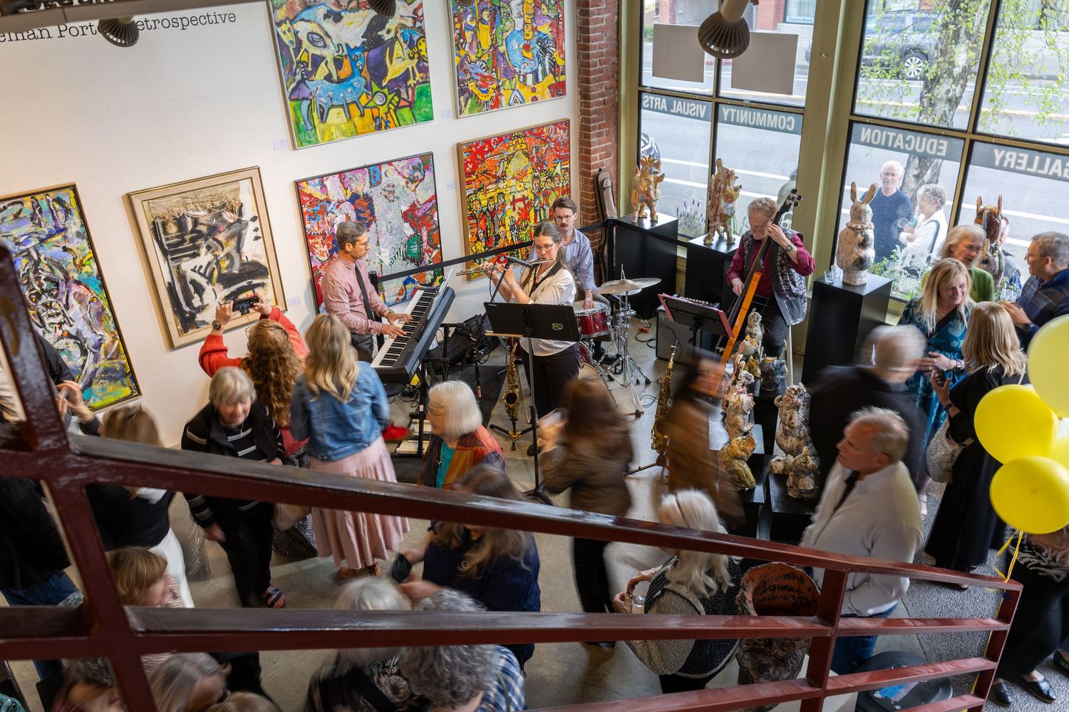 Attendees attend an art gallery opening in Kirkland.