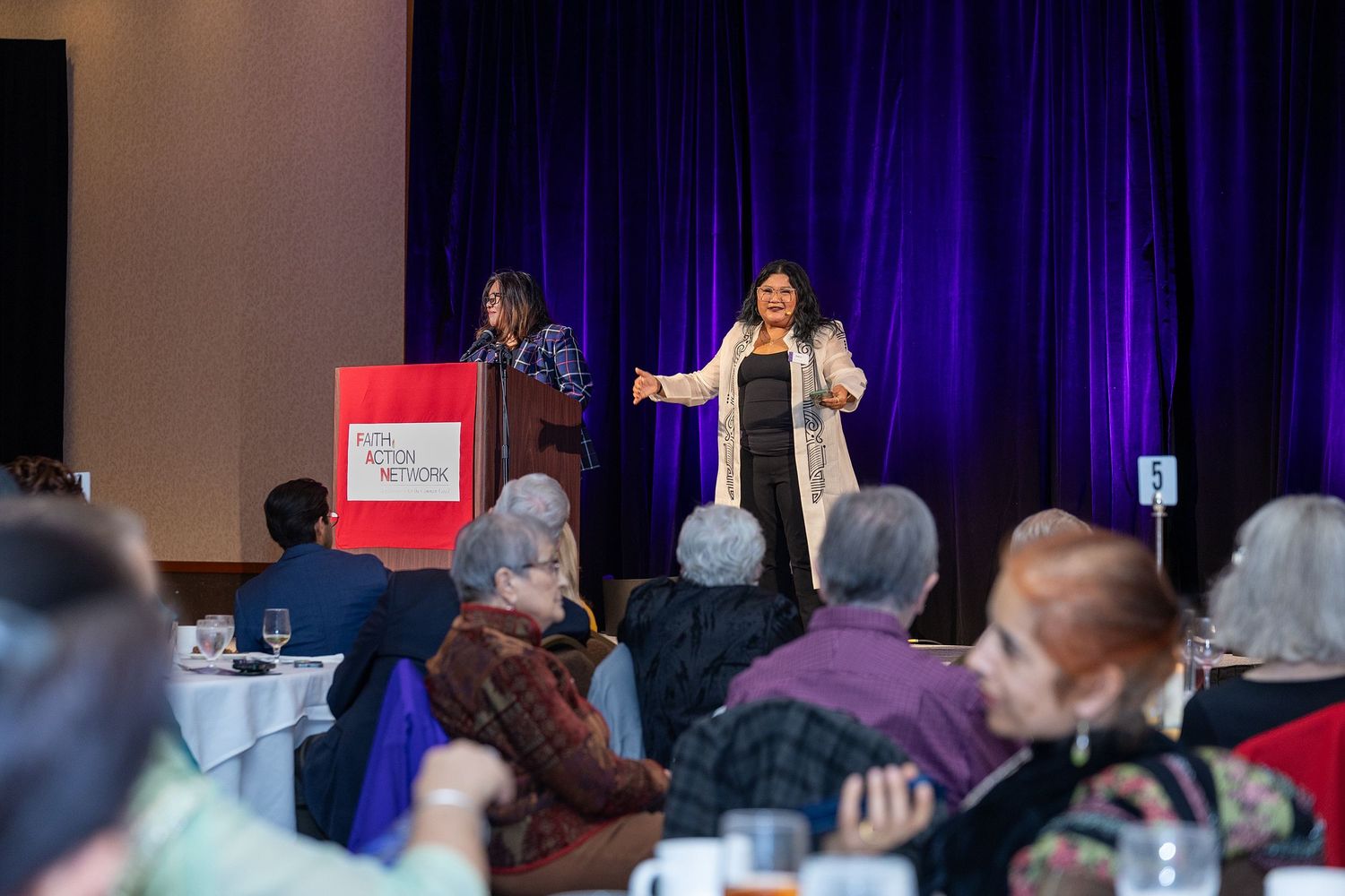 Presenters speaking to audience at a fundraising event in Seattle