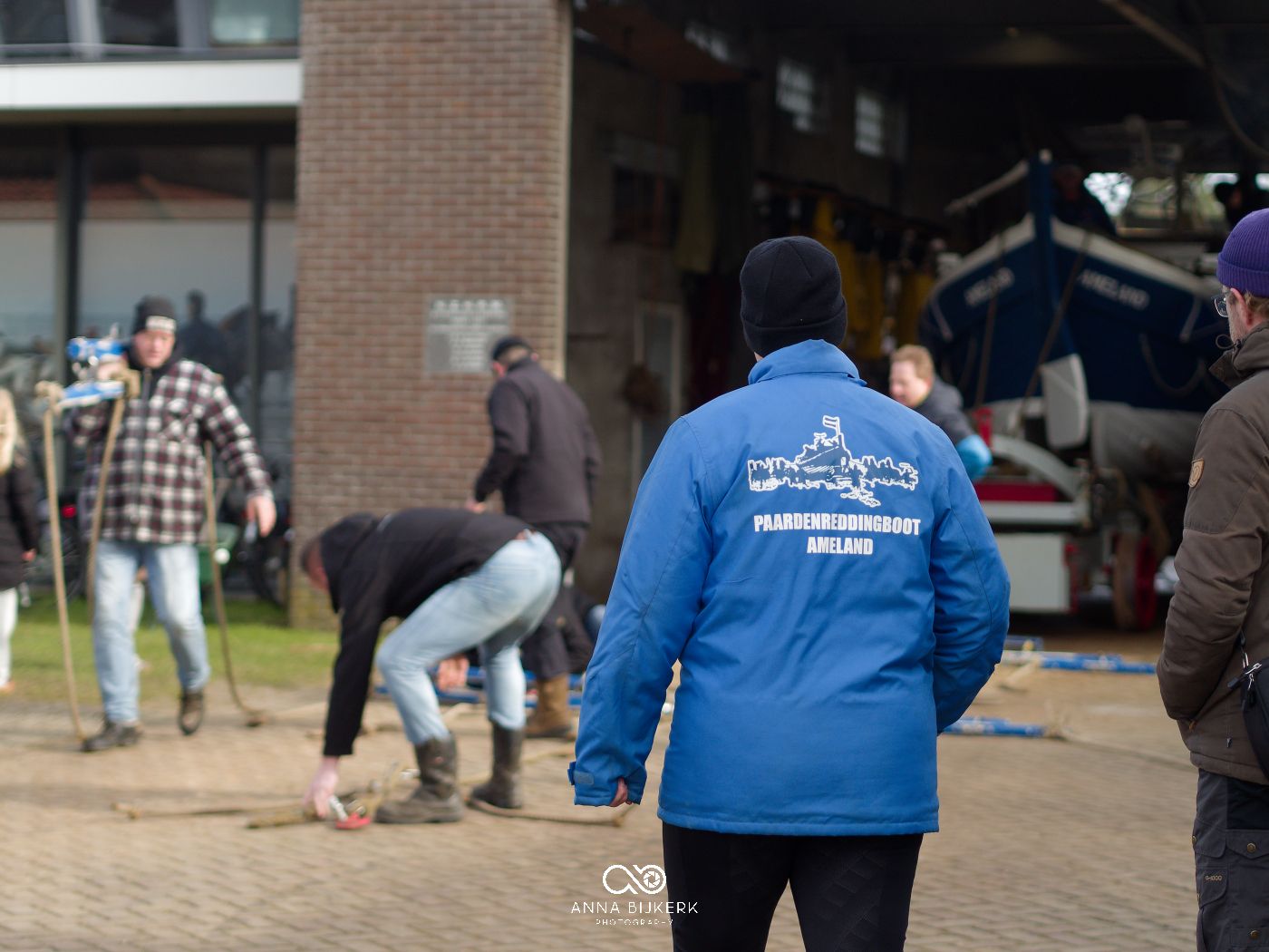 Group of volunteers in blue jackets working together at a community service event.