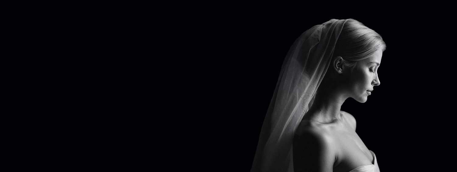 Elegant bride in black and white portrait wearing a veil, showcasing timeless bridal beauty. Martin Japheth Photography