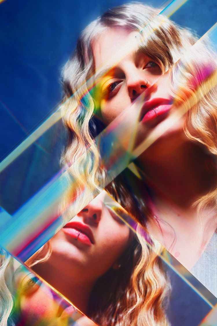 Prismatic portrait with rainbow light effects and diagonal geometric elements.