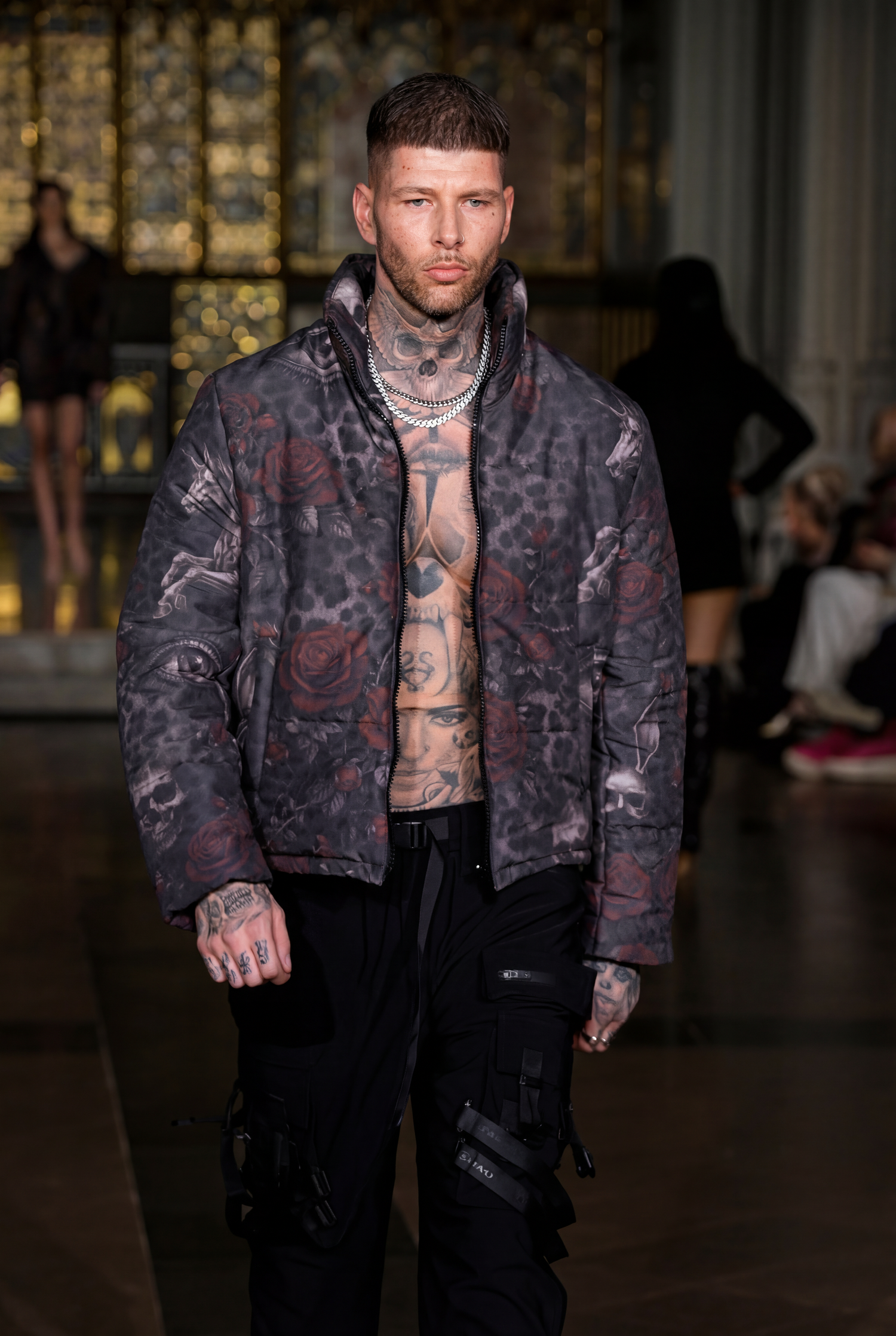 Mister Triple X Model walks runway wearing black pants and tie-dye patterned jacket at LFW26. Fashion Photographer Martin Japheth