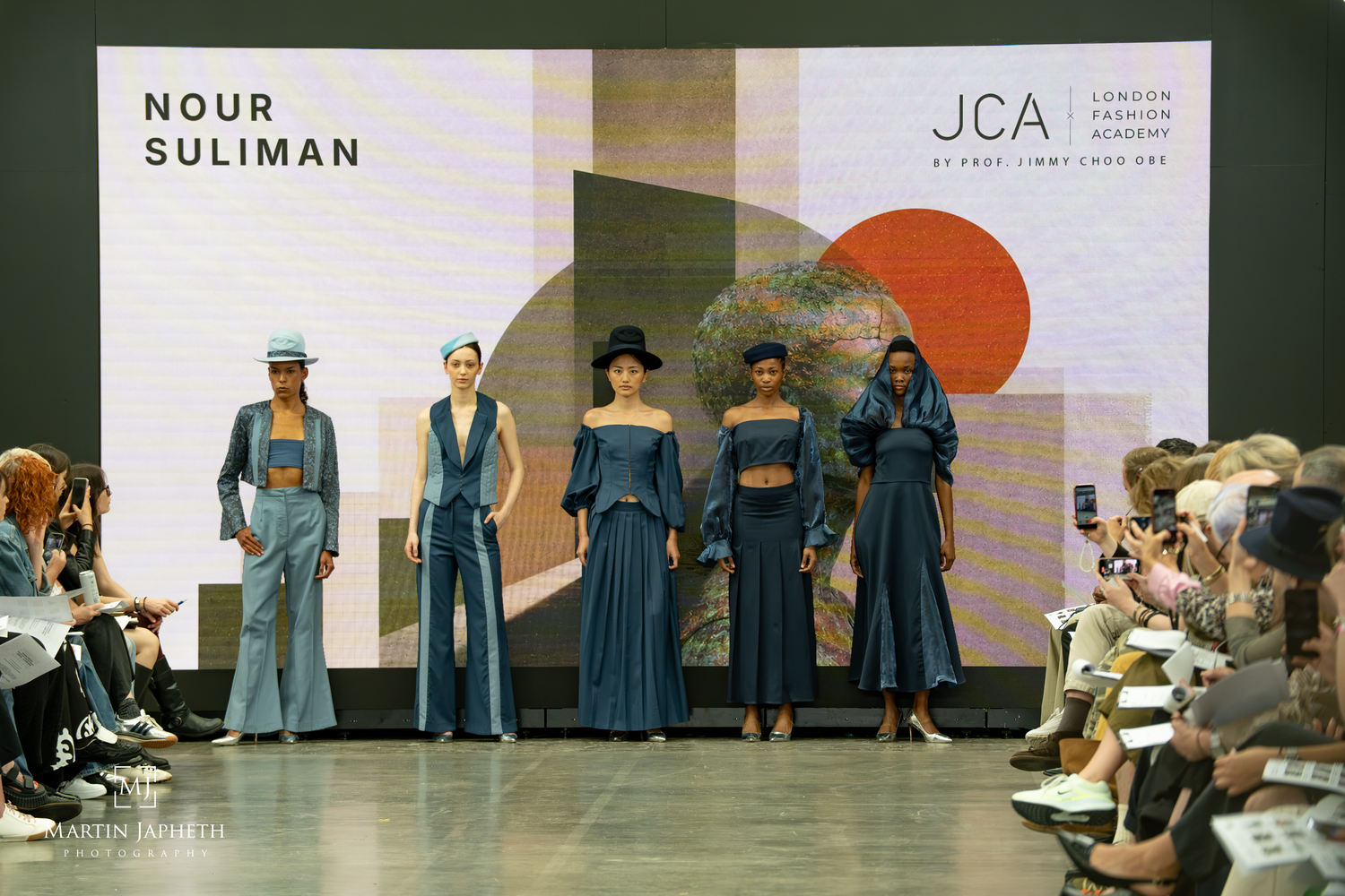 Models showcase Nour Suliman's collection on the runway at London Fashion Academy JCA graduate fashion show. Martin Japheth Photography