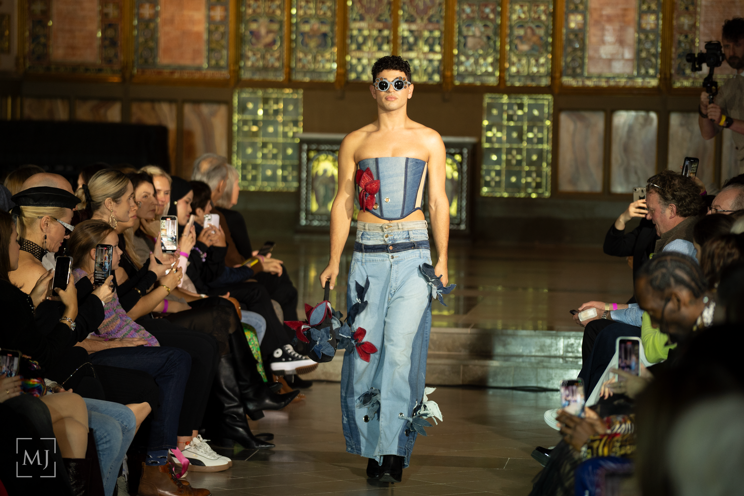 London Fashion Day runway show featuring model in denim outfit with floral appliques. Fashion Photographer Martin Japheth