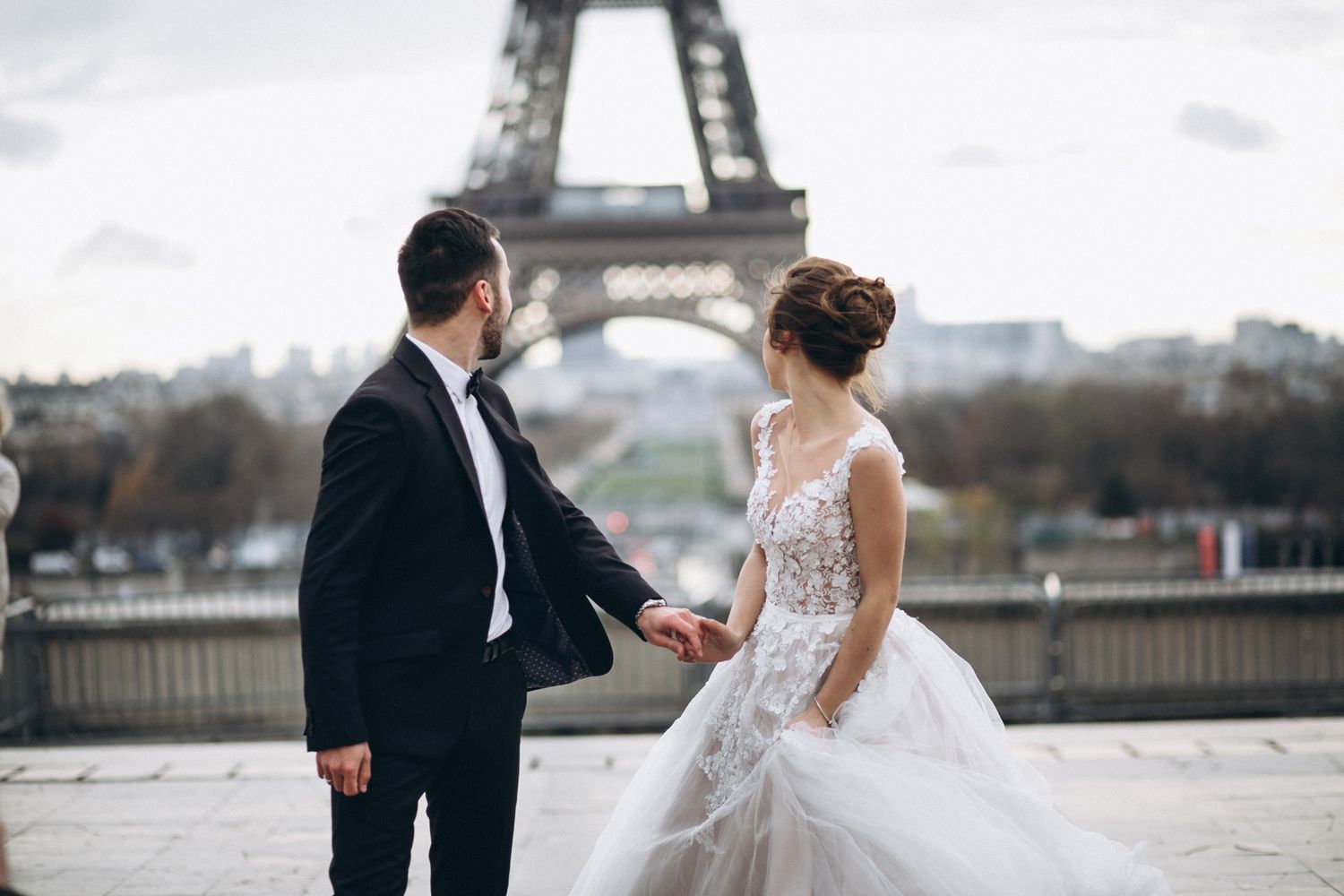 Holding hands near the Eiffel Tower in Paris, France. Martin Japheth Photography Paris Photoshoot
