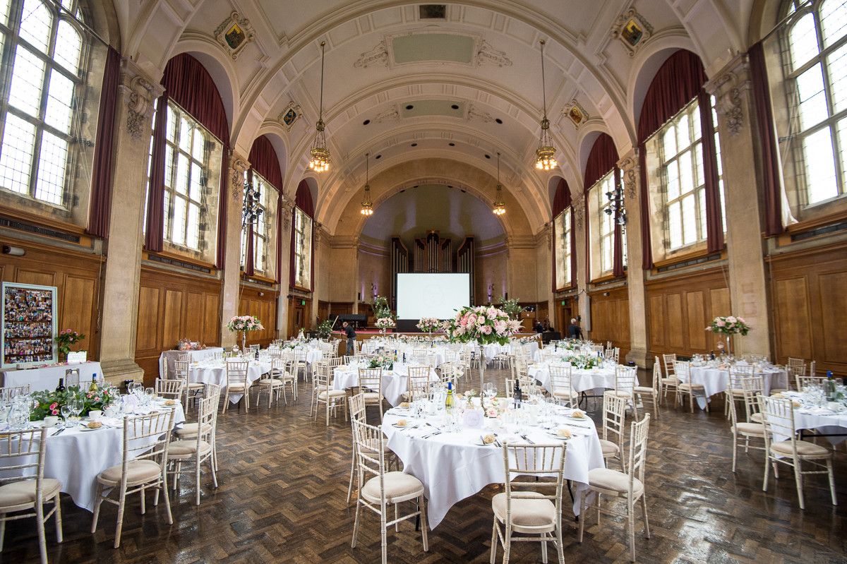 Elegant wedding reception hall with round white-draped tables, chiavari chairs | Martin Japheth Photography