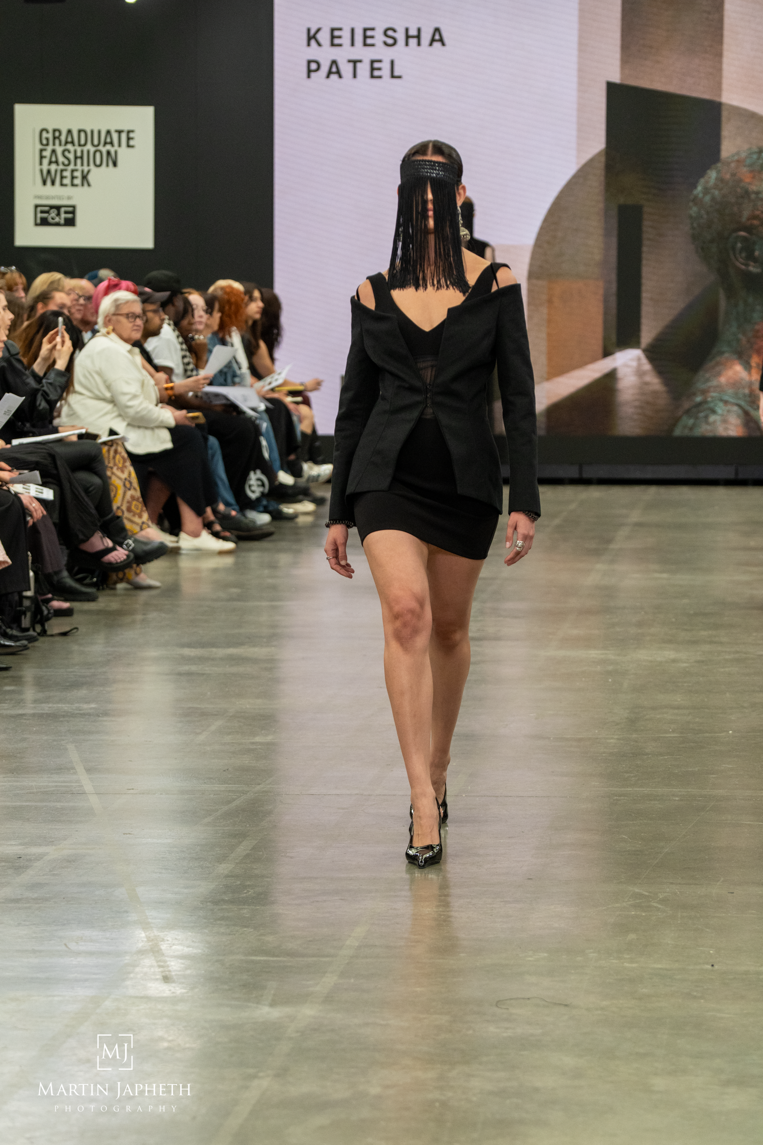 Graduate Fashion Week wearing Keiesha Patel black structured mini dress with cutout shoulders. Martin Japheth Photography