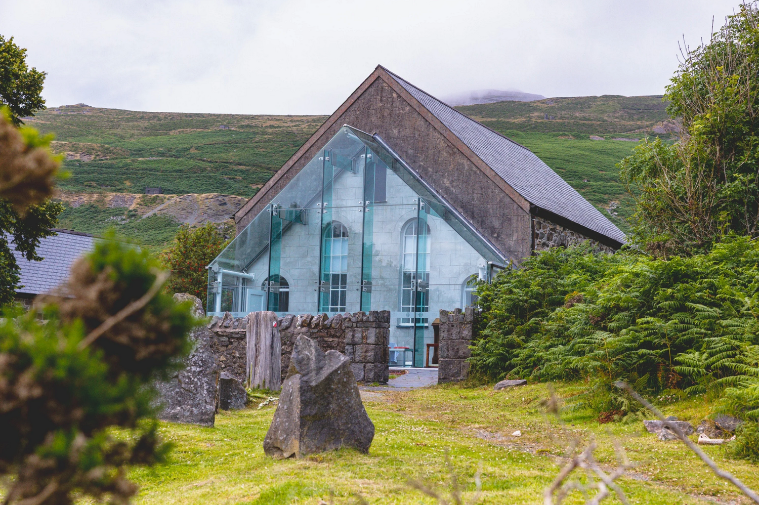 Modern glass-fronted house with stone walls nestled in Nant Gwrtheyrn Wedding Fayre.