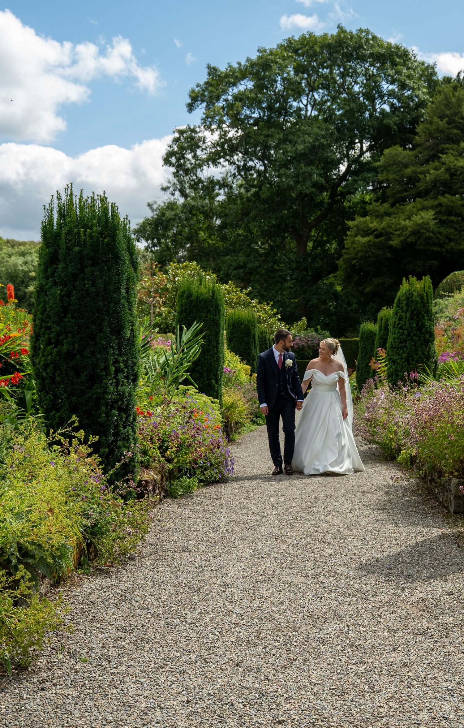 Bride and groom at golden hour in the hidden gardens of Plas Cadnant, Anglesey wedding photography