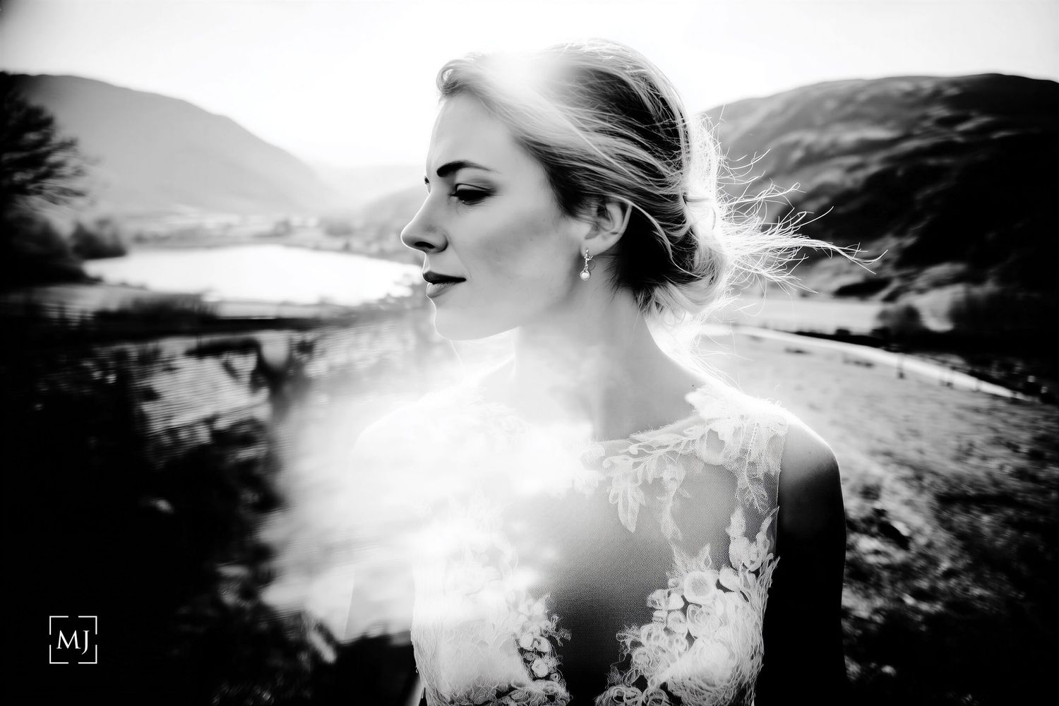 Artistic double exposure wedding portrait combining bride and mountain landscape in monochrome. Martin Japheth Photography