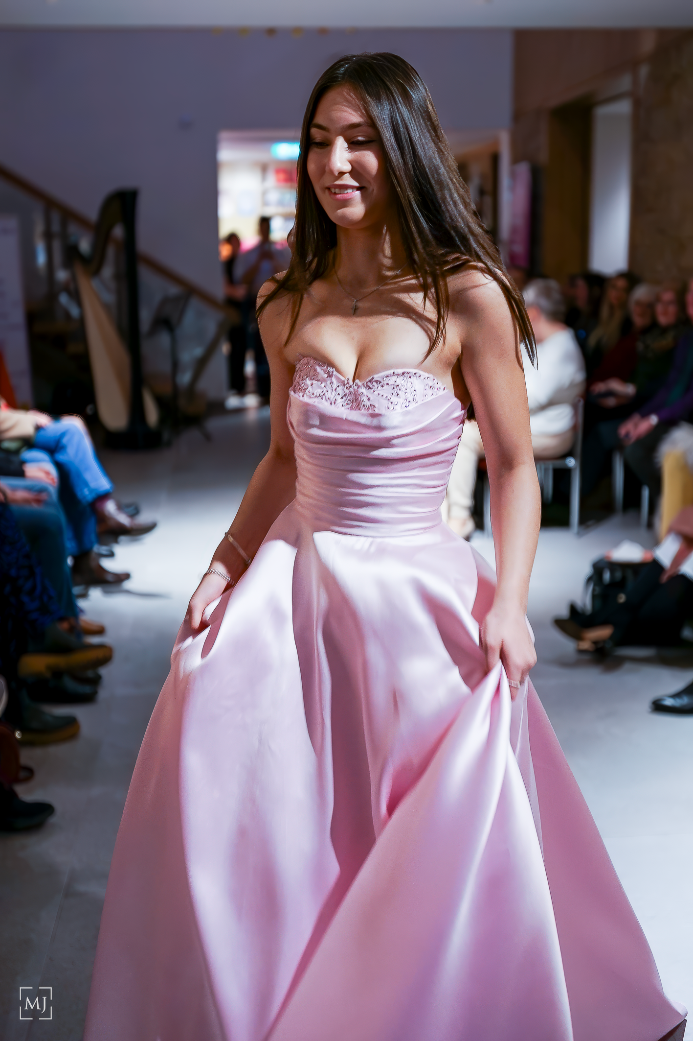 Model showcases elegant pink satin ball gown with pockets on fashion runway. Fashion Photographer Martin Japheth