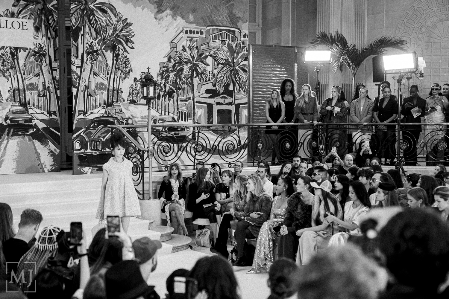 A collage of black and white wedding photos showing reception moments, dancing, and ceremony scenes with palm trees.