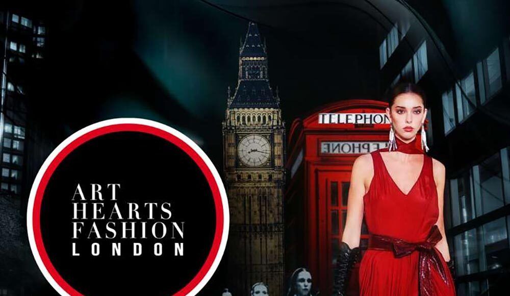 Fashion model in red dress poses against London cityscape with Big Ben and Art Hearts Fashion London branding.