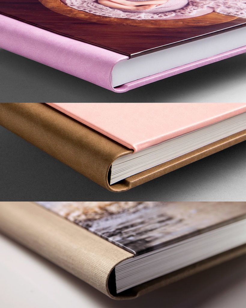 Three close-up views of hardcover photo books with fabric spines in pink, gold, and tan bindings.
