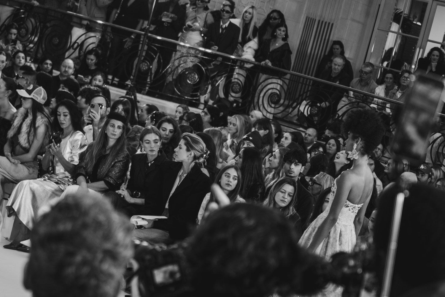 Large crowd of wedding guests gathered at an elegant indoor reception venue.